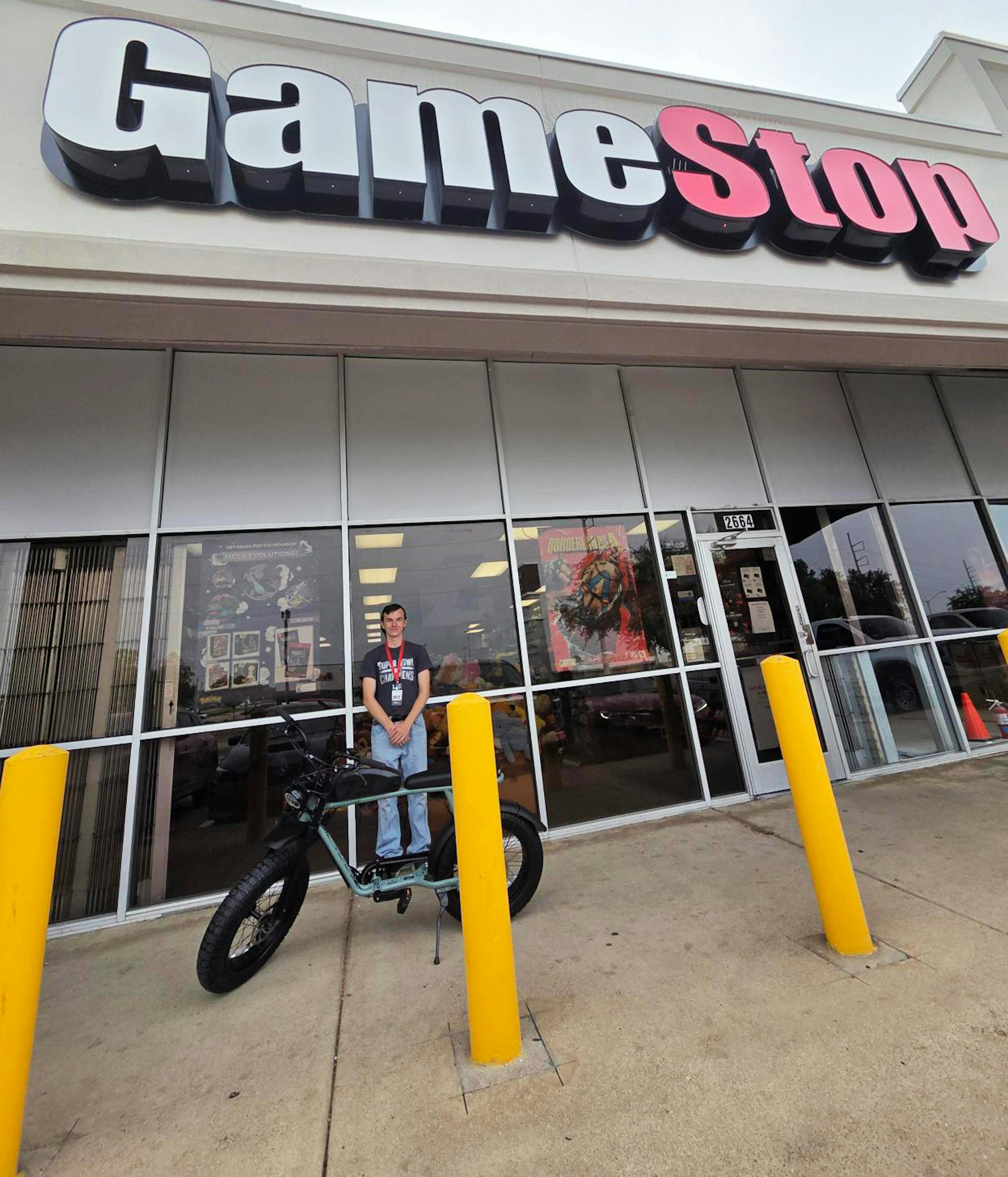 James poses with his new e-bike outside a GameStop store