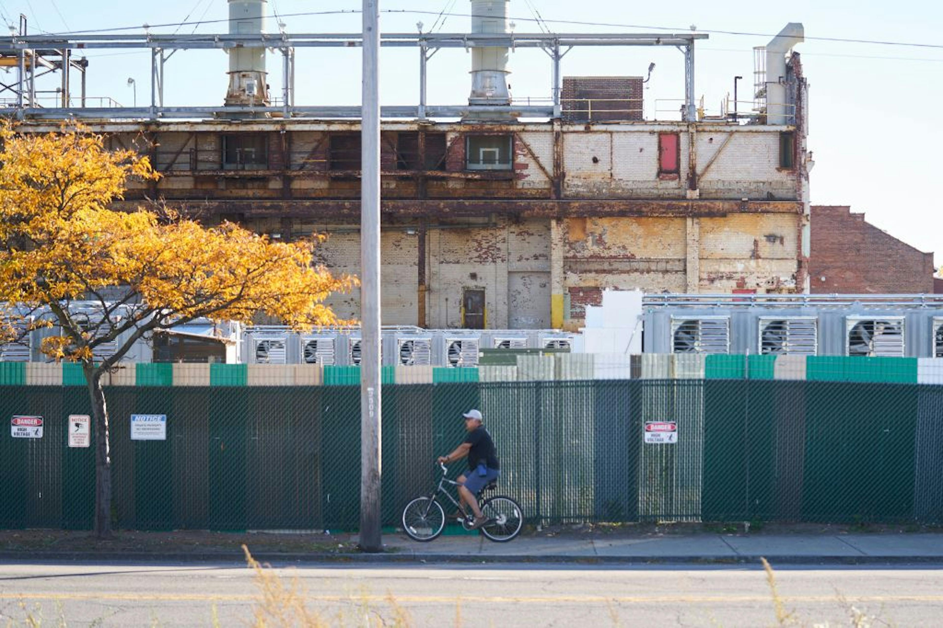 A person on a bicycle rides past the US Bitcoin facility in Niagara Falls, New York on October 24, 2022.