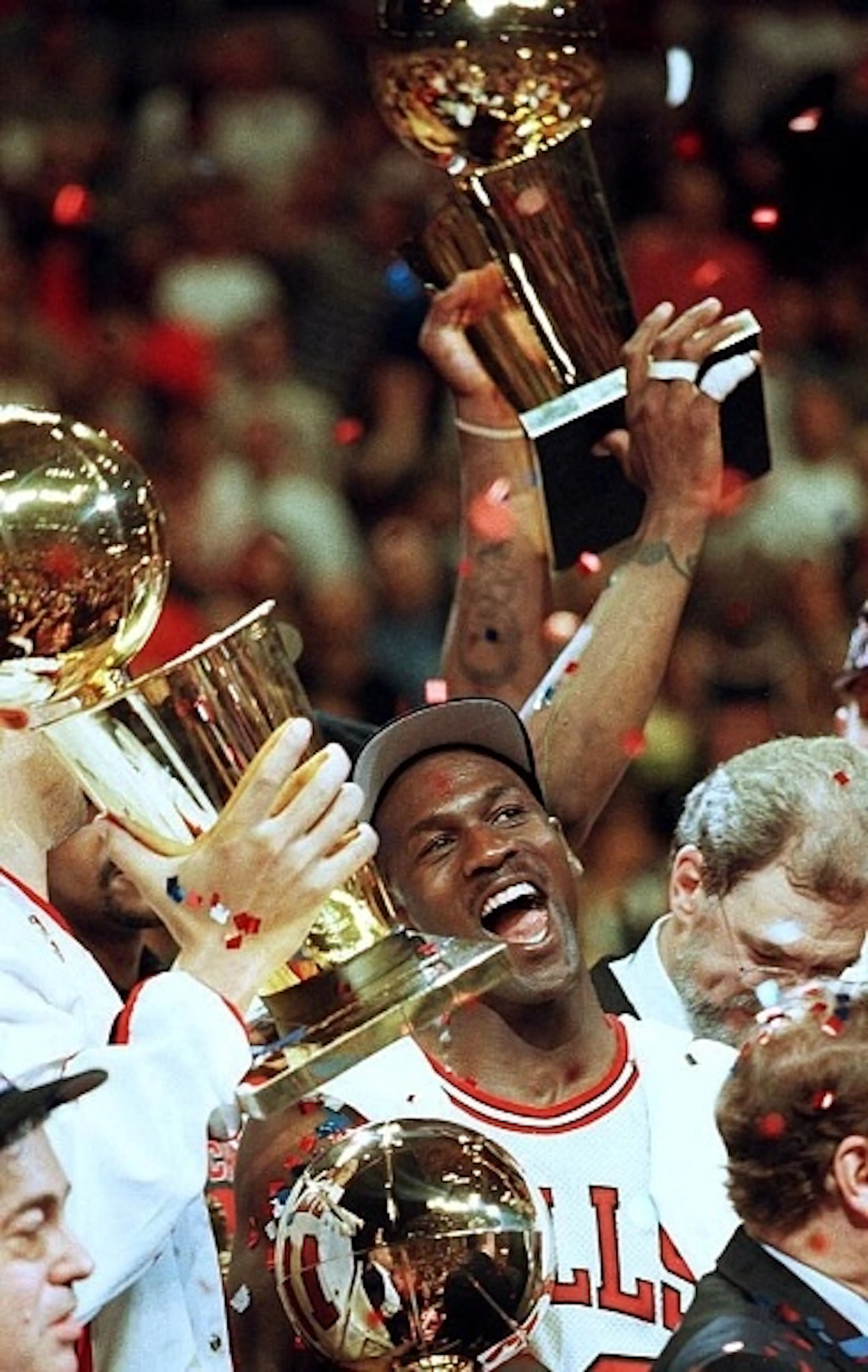 Chicago Bulls player Michael Jordan is surrounded by NBA Championship trophies after his team defeated the Utah Jazz 90-86 to win the 1997 NBA Finals at the United Center in Chicago, IL.