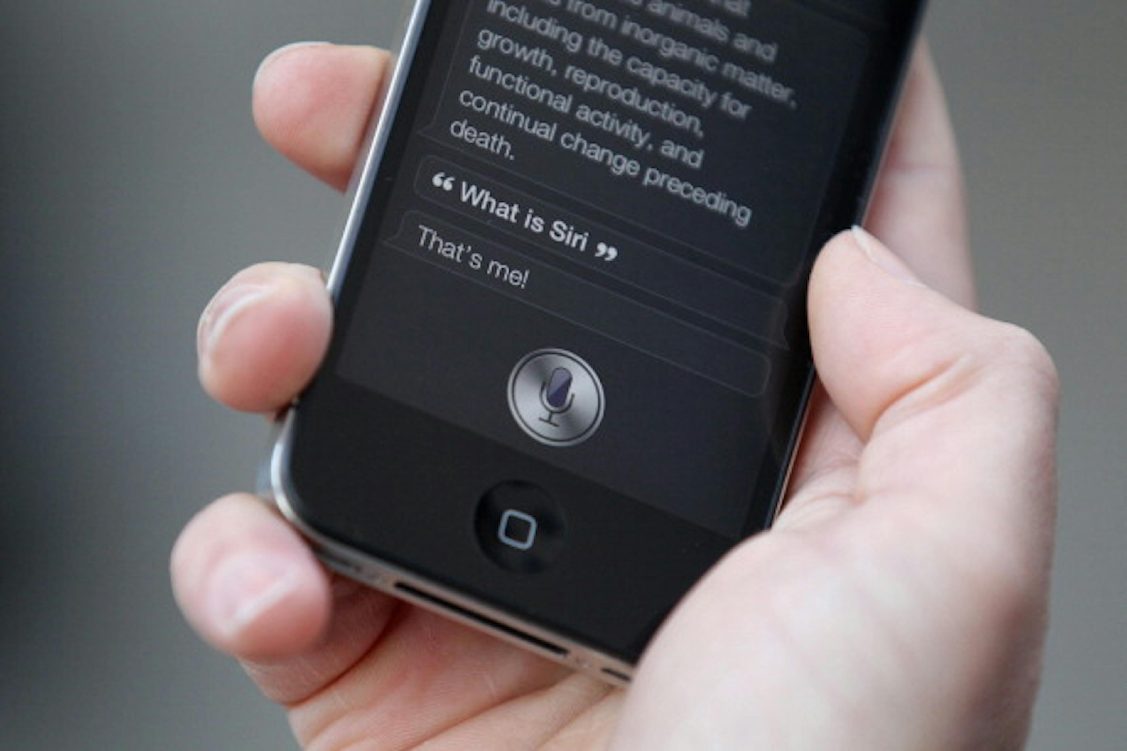 Siri conversation on a phone screen in hand