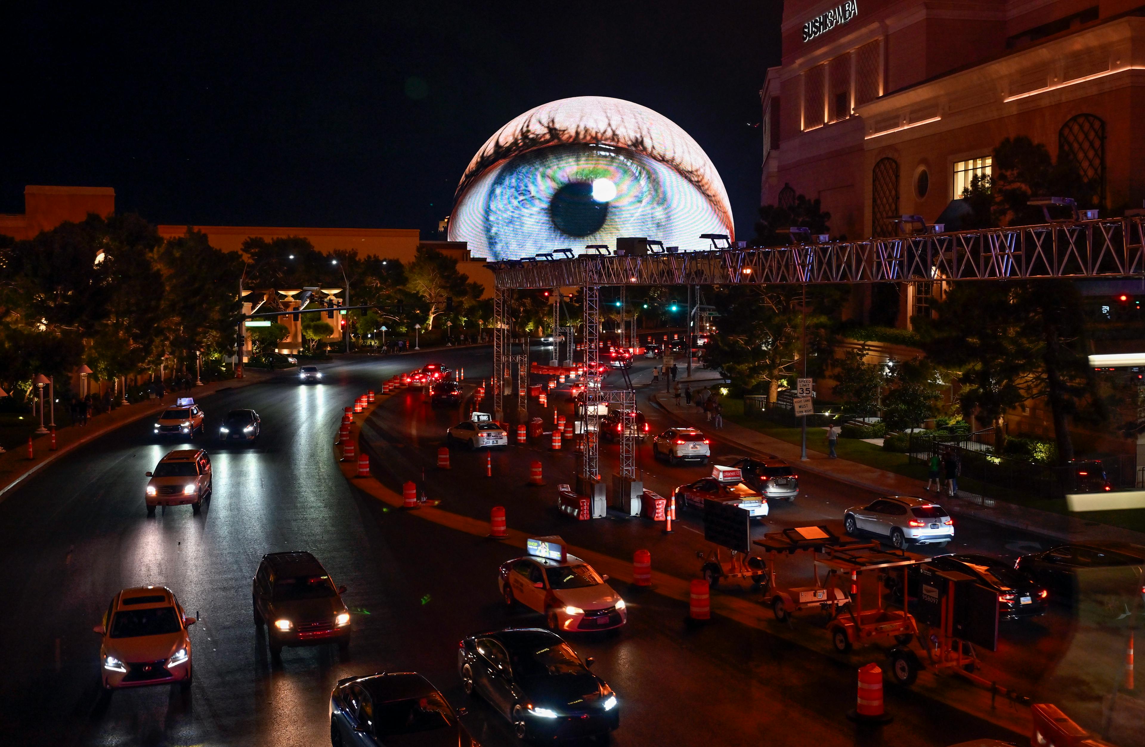 An eye ball is displayed on the Sphere appears to look down on vehicle traffic in Las Vegas.