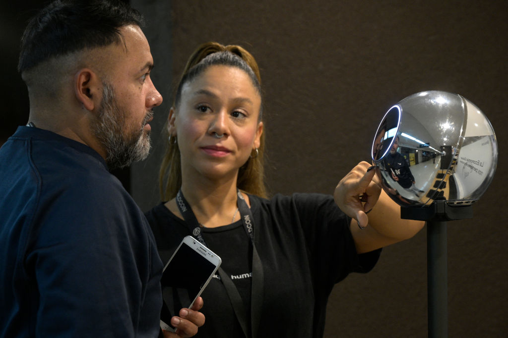 A man has his iris scanned with an orb, a biometric data scanning device, in exchange for the Worldcoin cryptocurrency in Buenos Aires on March 22, 2024. 