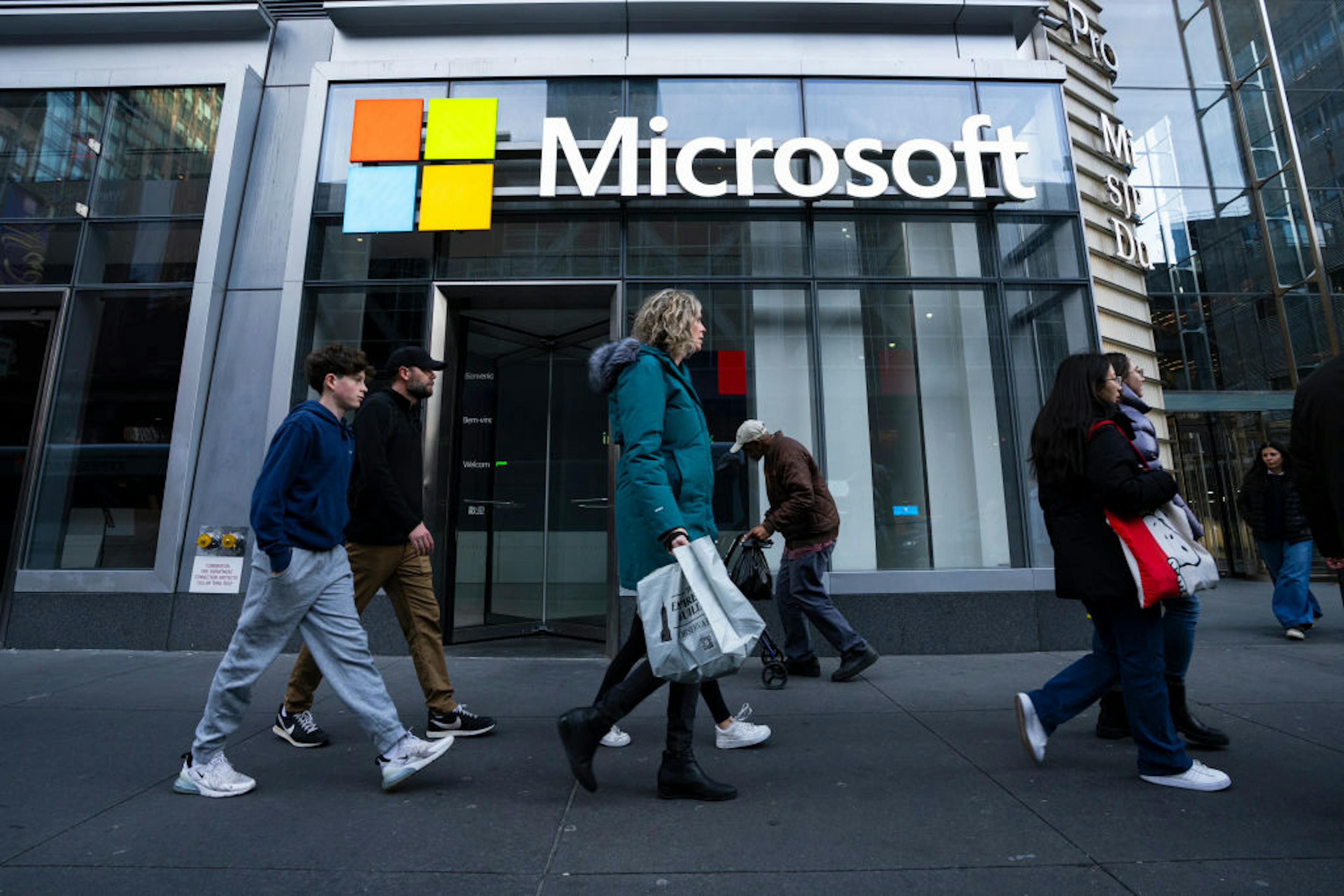 People walk by the Microsoft Office building on 41st street and 8th avenue on November 25, 2024 in New York City.