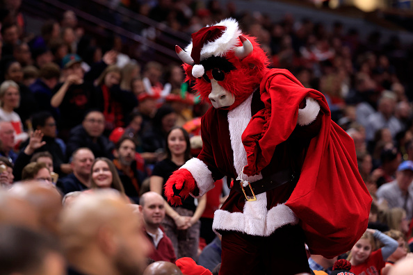 CHICAGO, ILLINOIS - DECEMBER 23: Benny the Bull, the Chicago Bulls mascot, dresses as Santa Claus in the game against the Milwaukee Bucks during the second half at the United Center on December 23, 2024 in Chicago, Illinois