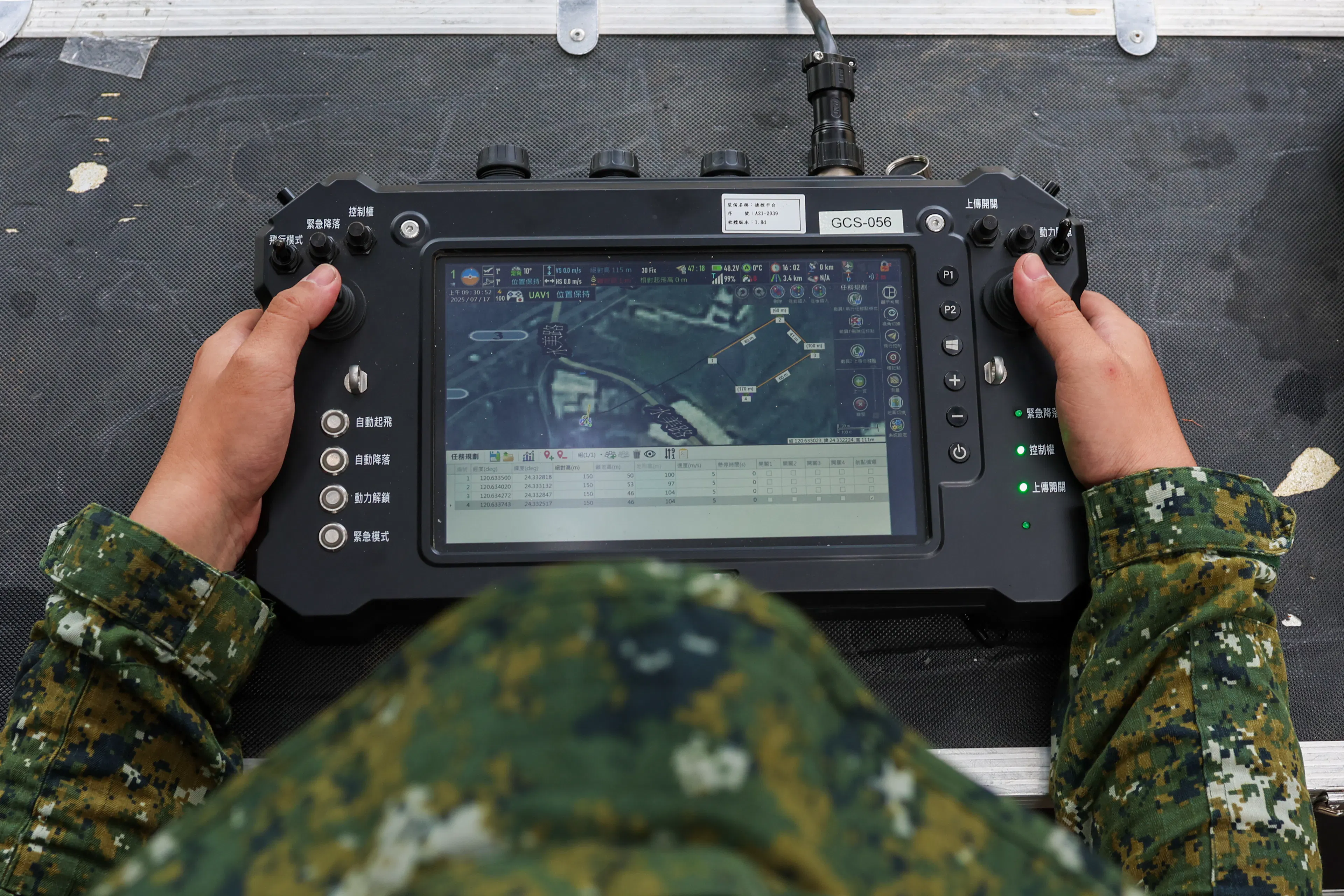 A Taiwanese reconnaissance soldier is seen holding the remote controller of a Taiwan-made tactical short-range surveillance drone, during a deep battle exercise