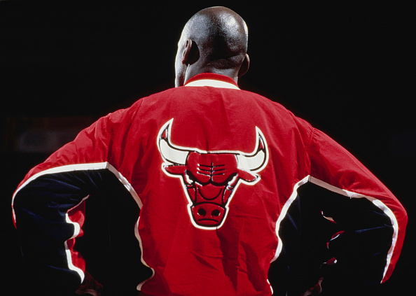 Michael Jordan #23, Shooting Guard and Small Forward for the Chicago Bulls wearing a warm up jacket looks on during player introductions before the NBA Midwest Division basketball game against the Denver Nuggets 