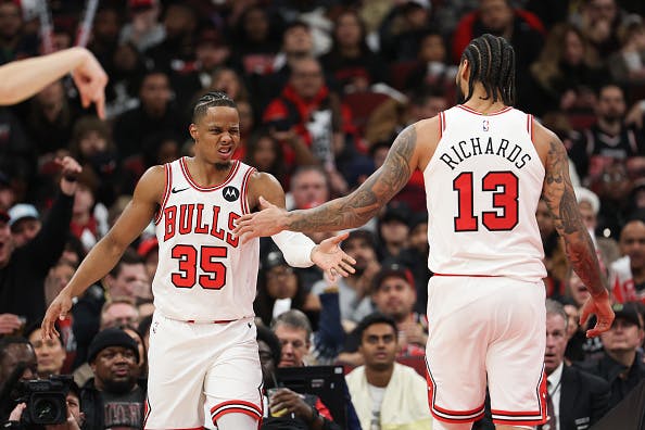 Nick Richards #13 and Isaac Okoro #35 of the Chicago Bulls celebrate after play against the Denver Nuggets during the third quarter at the United Center on February 07, 2026 in Chicago, Illinois.