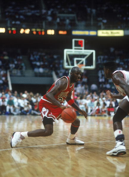 Michael Jordan #23 dribbles towards the net circa the 1990's during a game.