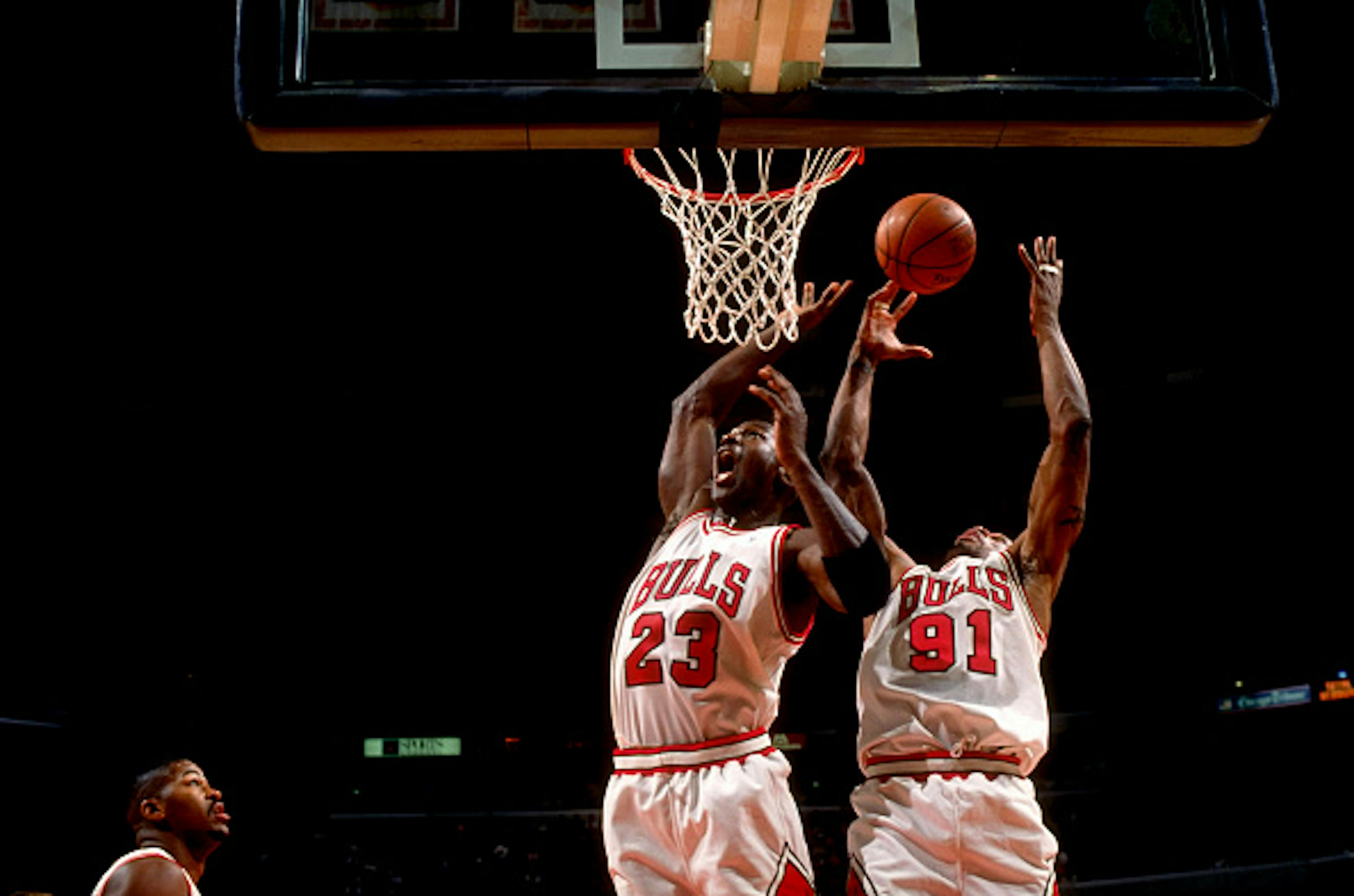 Chicago Bulls Dennis Rodman (91) and Michael Jordan (23) in action, rebounding vs Charlotte Hornets
