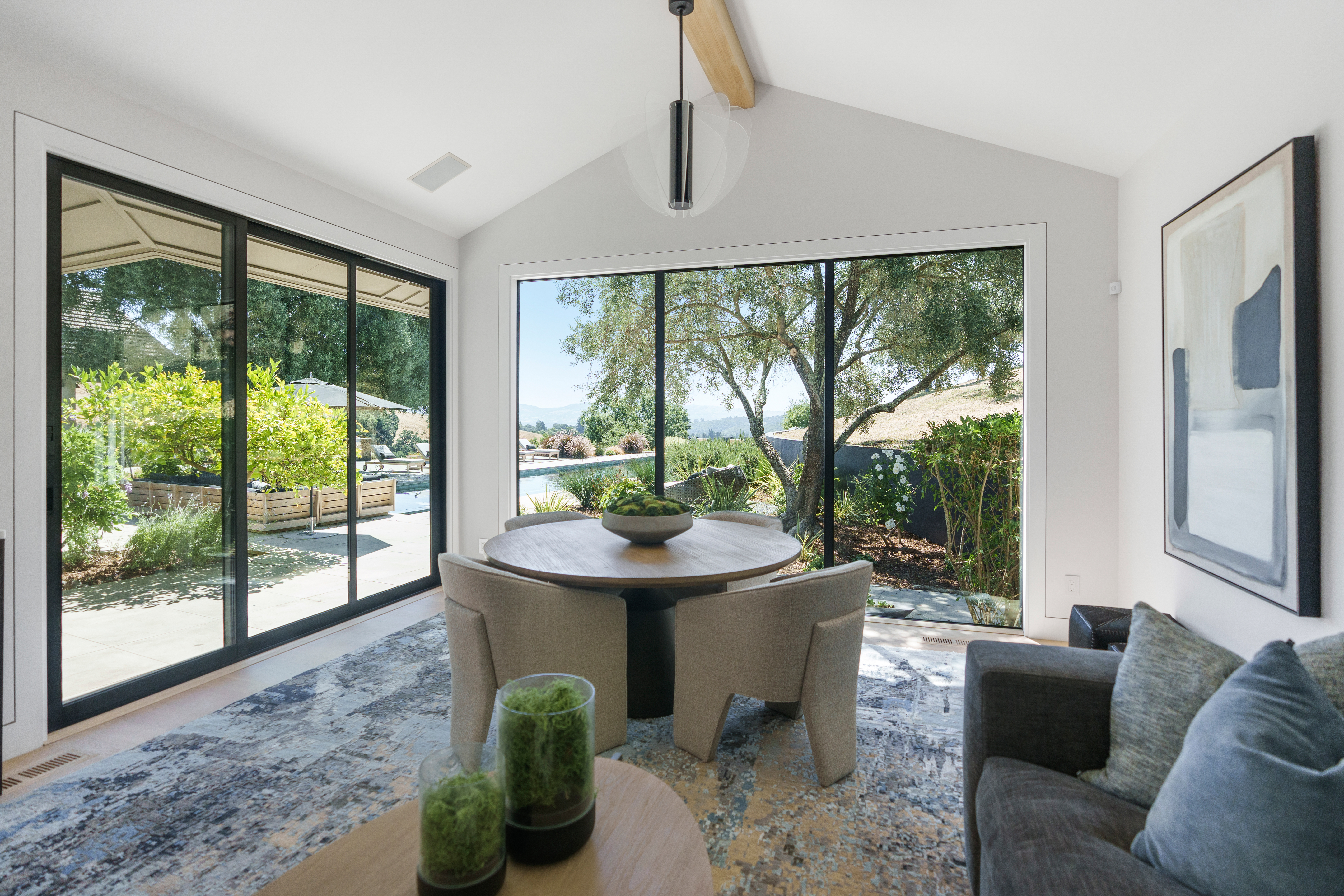 A view of a pool and outdoor area from inside a luxury home