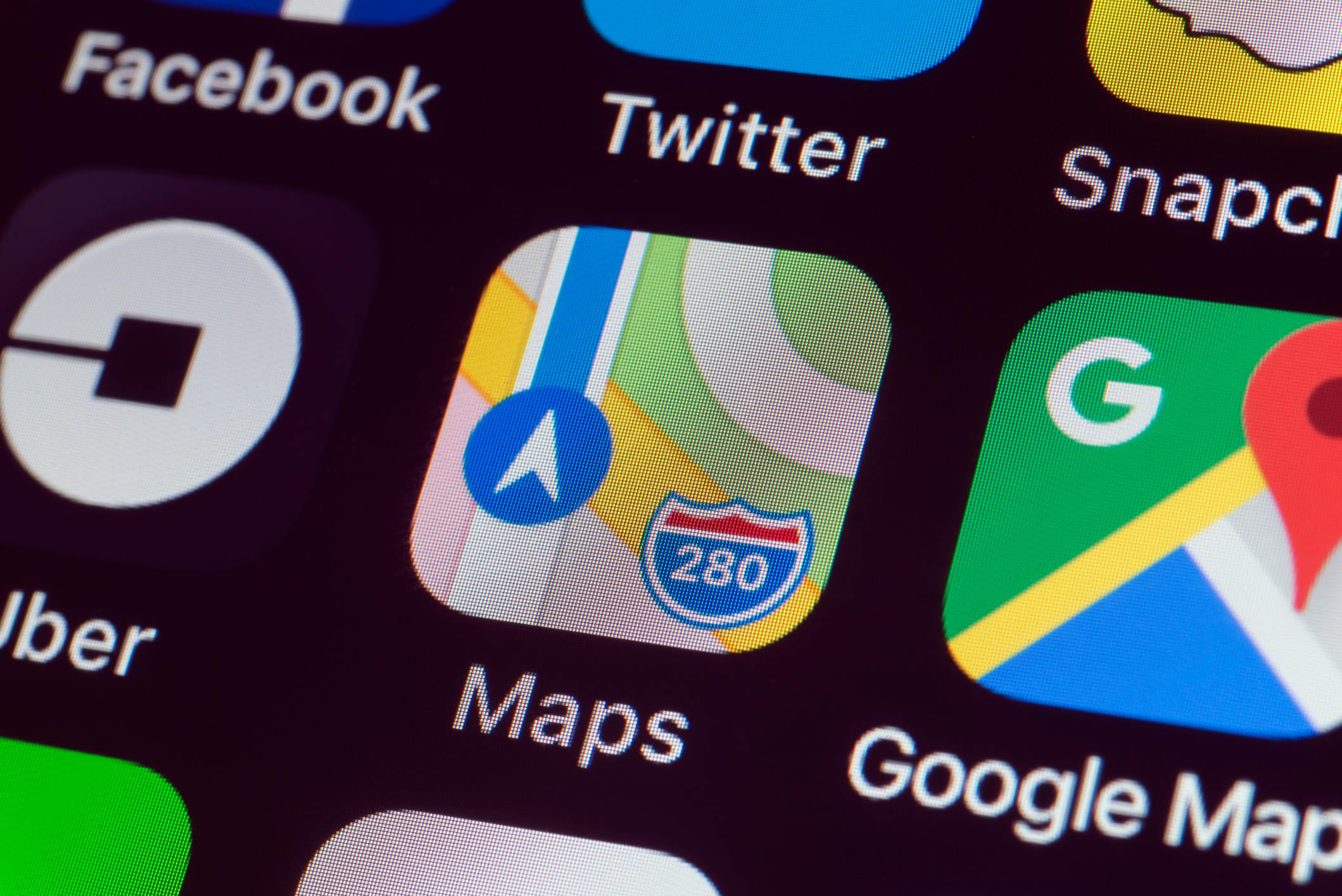 Apple Maps, Google Maps, Uber and other Apps on iPhone screen