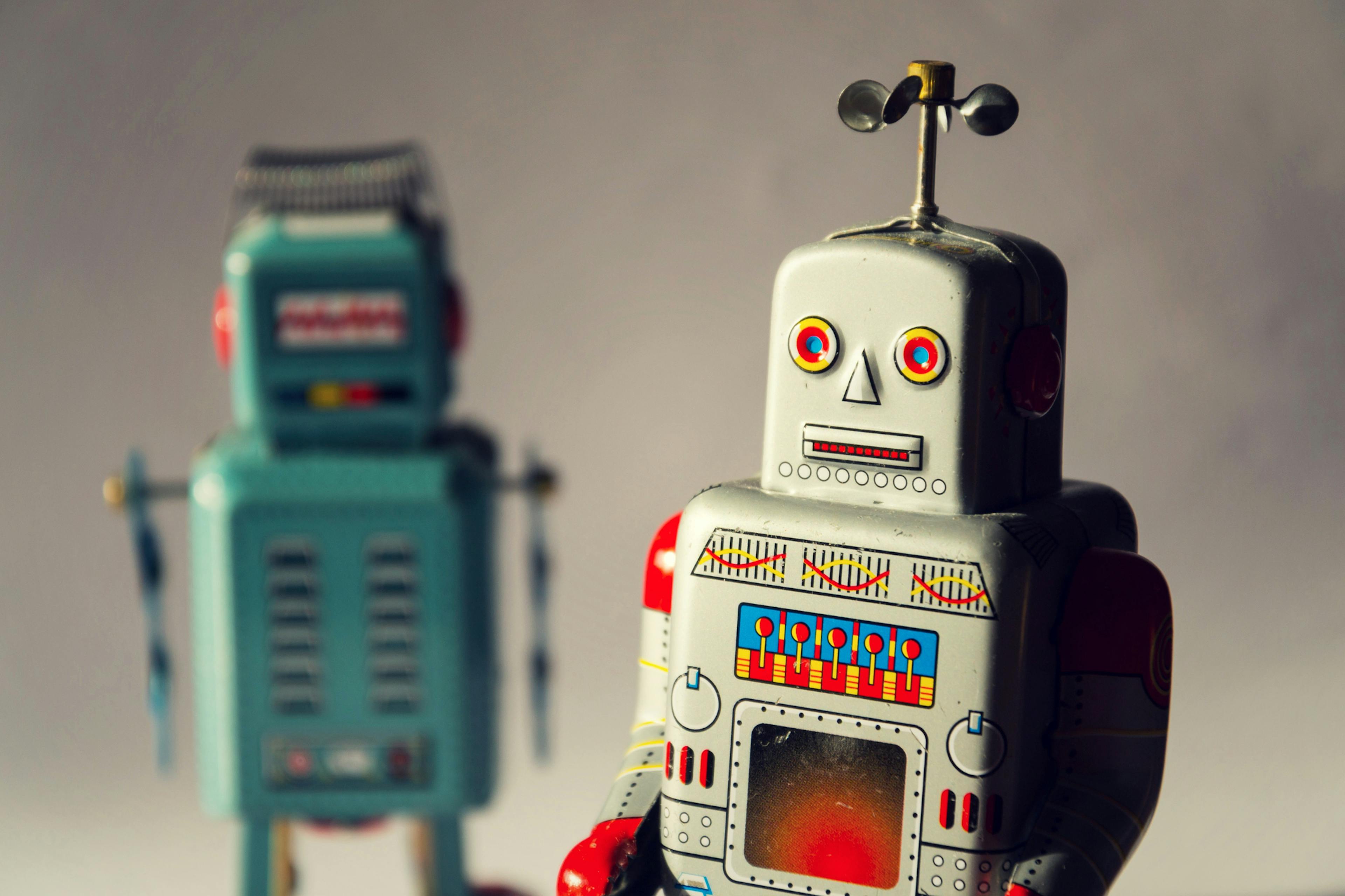 Two vintage tin toy robots, robotic delivery, artificial intelligence concept