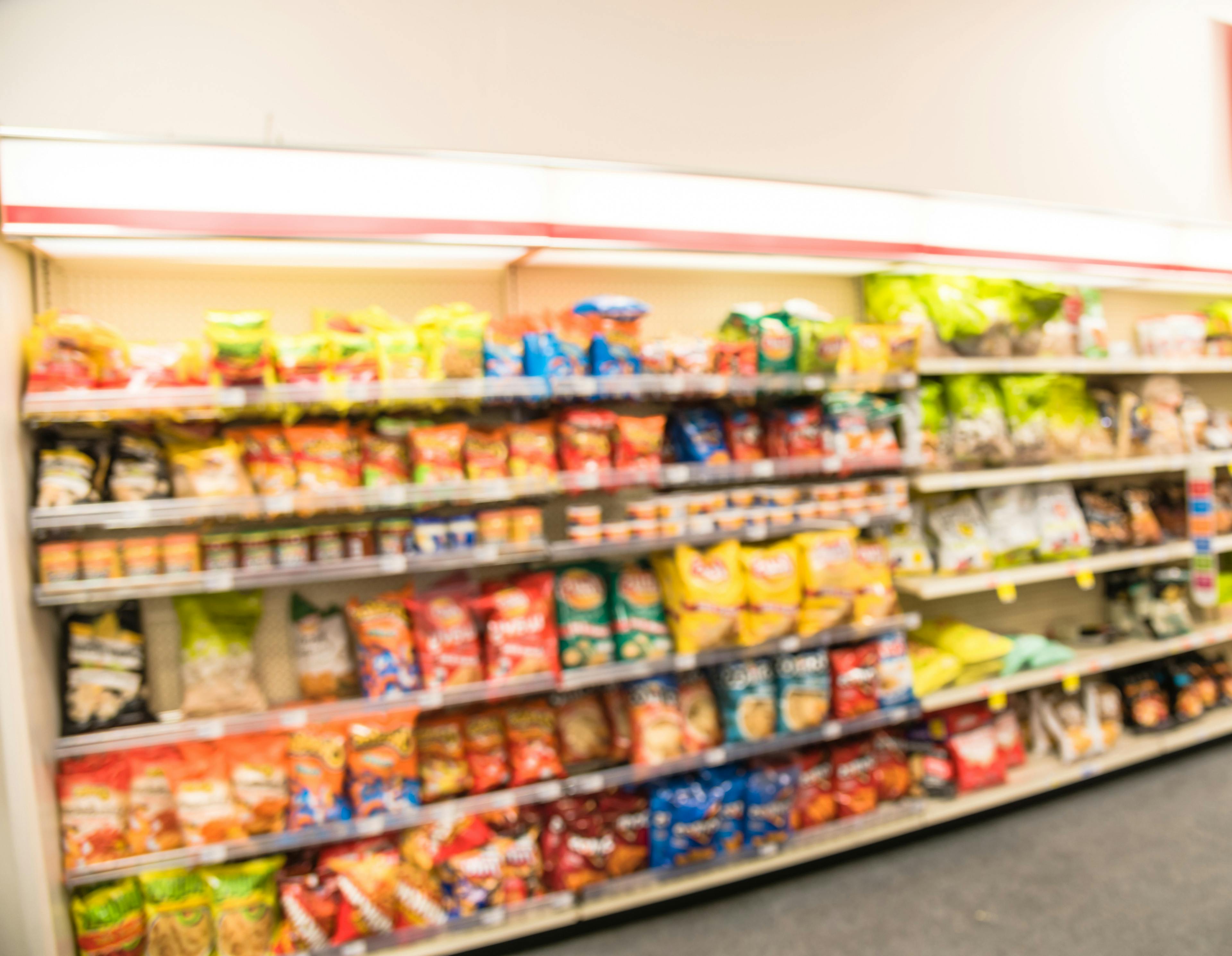 Blurry background snacks and canned chips at pharmacy store in America