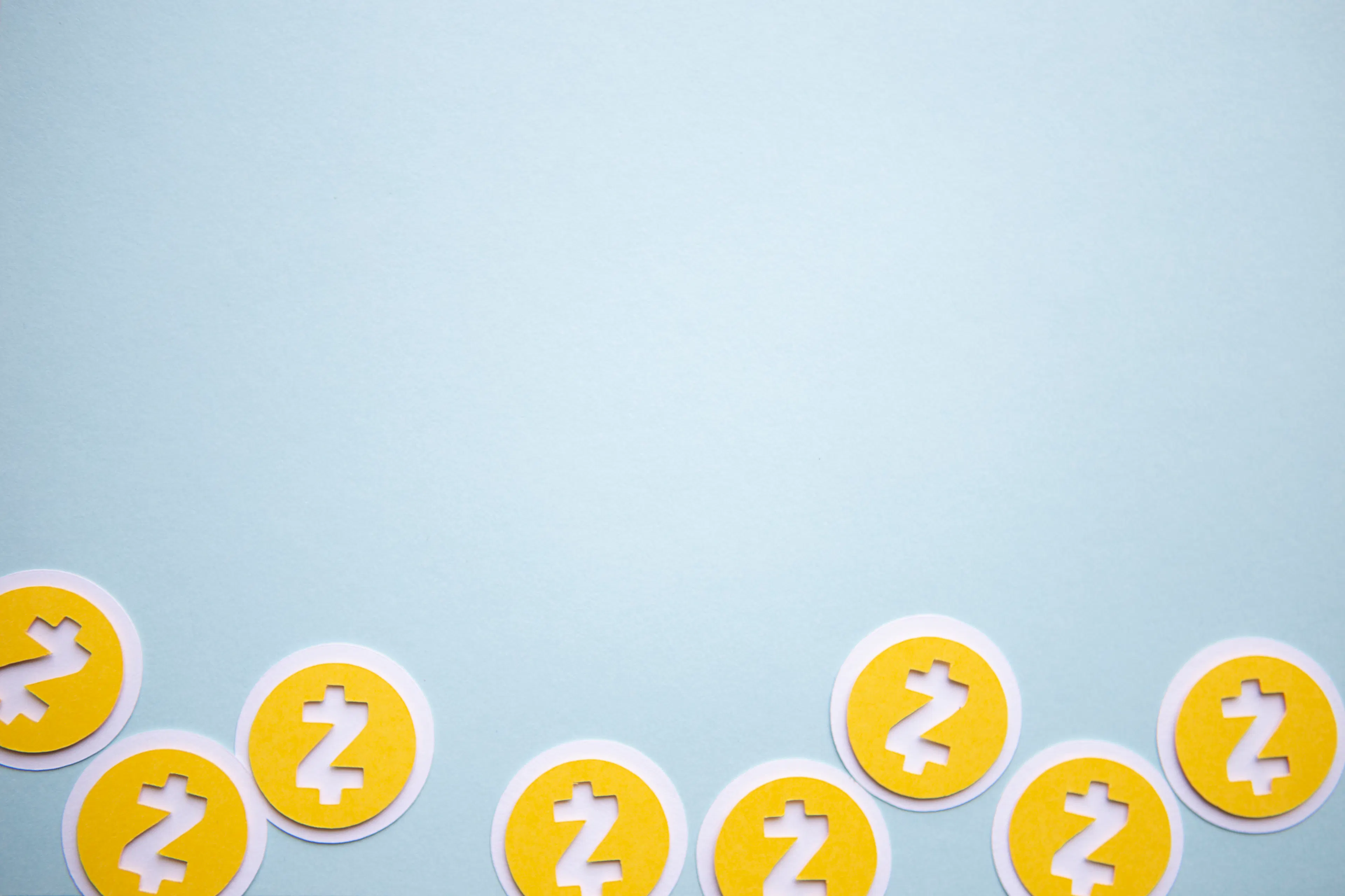 Zcash coins on blue background.
