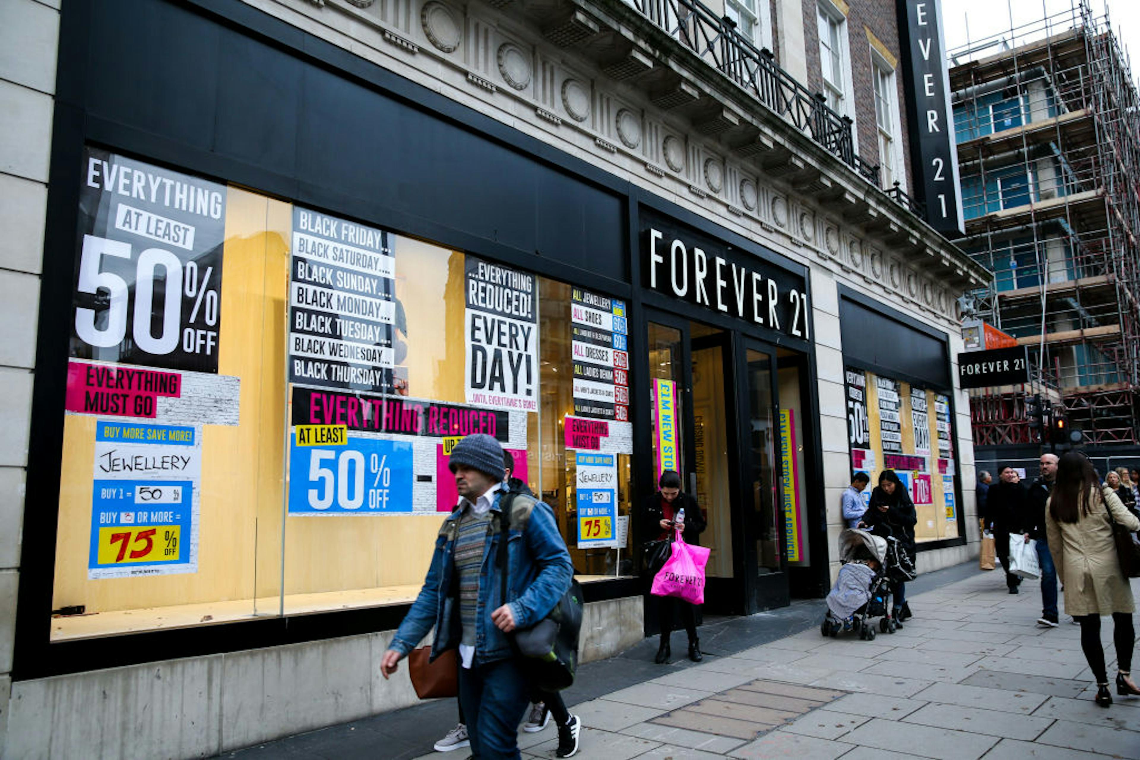 Shoppers walk past closing Forever 21