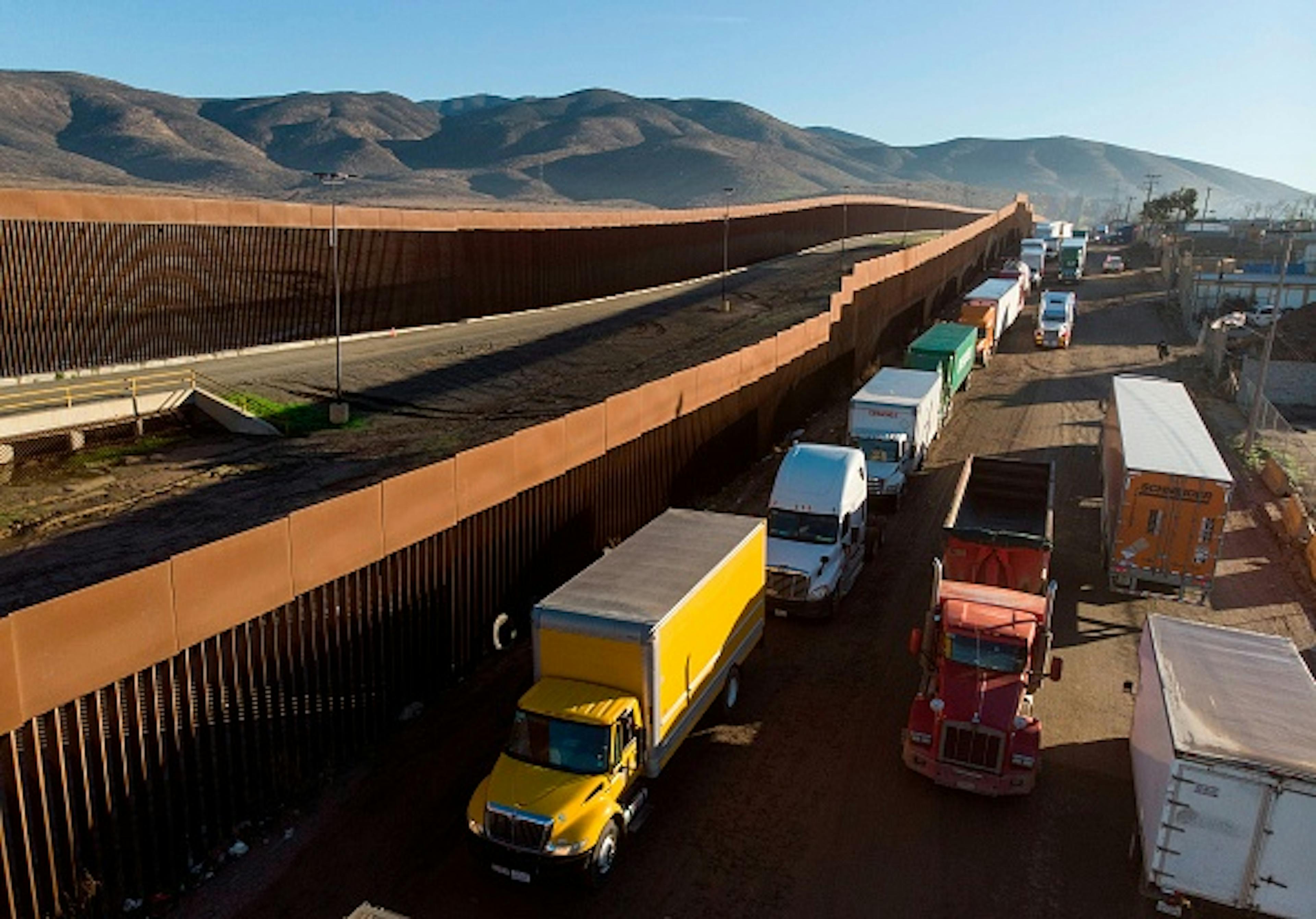 Aerial view of trucks lining up near the border fence to cross to the United States at Otay Commercial port of entry in Tijuana, Baja California state, Mexico