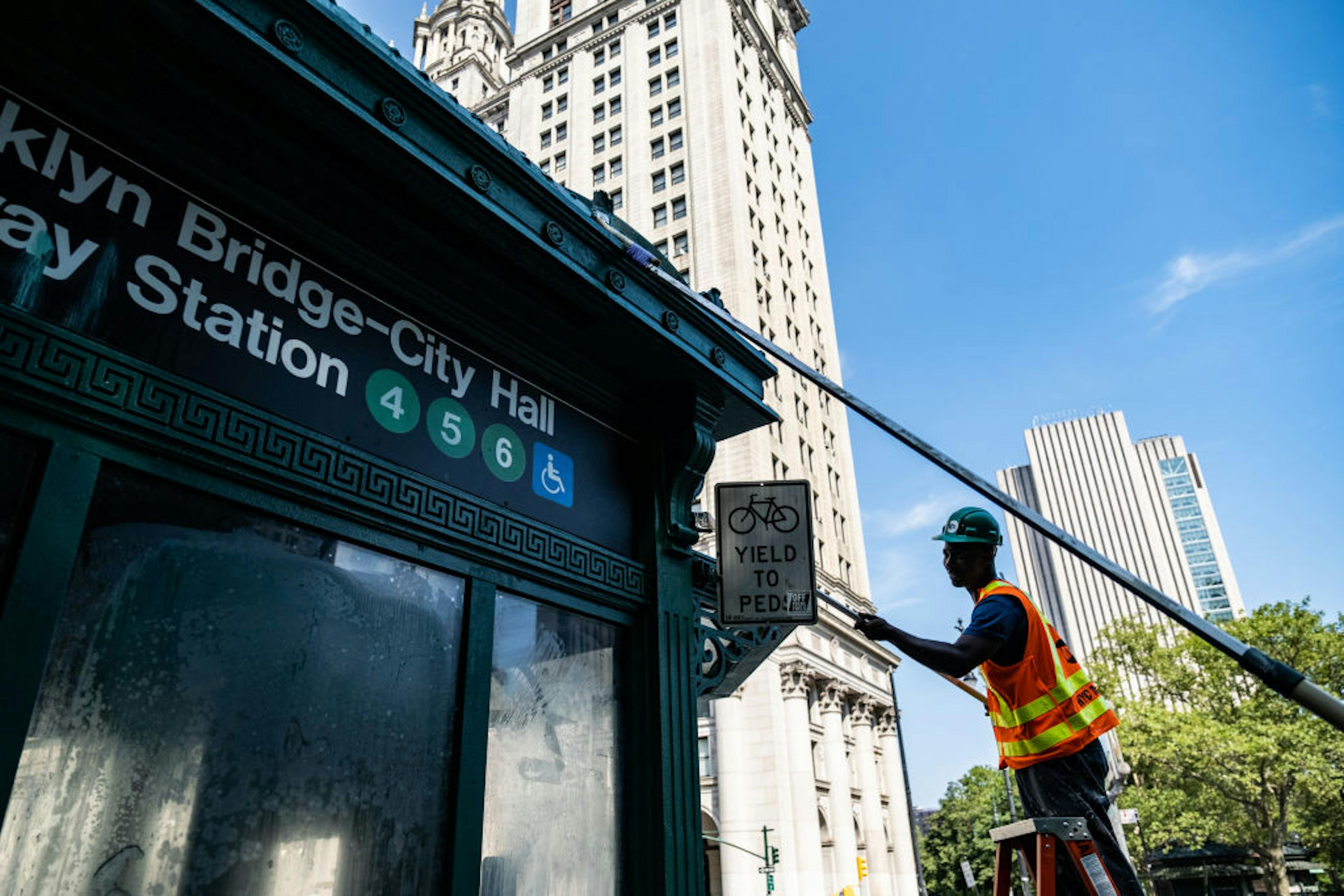 Worker painting subway entrance