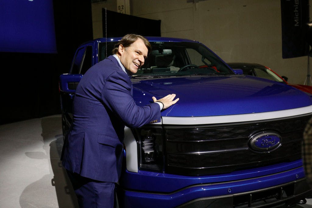 Ford CEO Jim Farley touching an F-150 Lightning