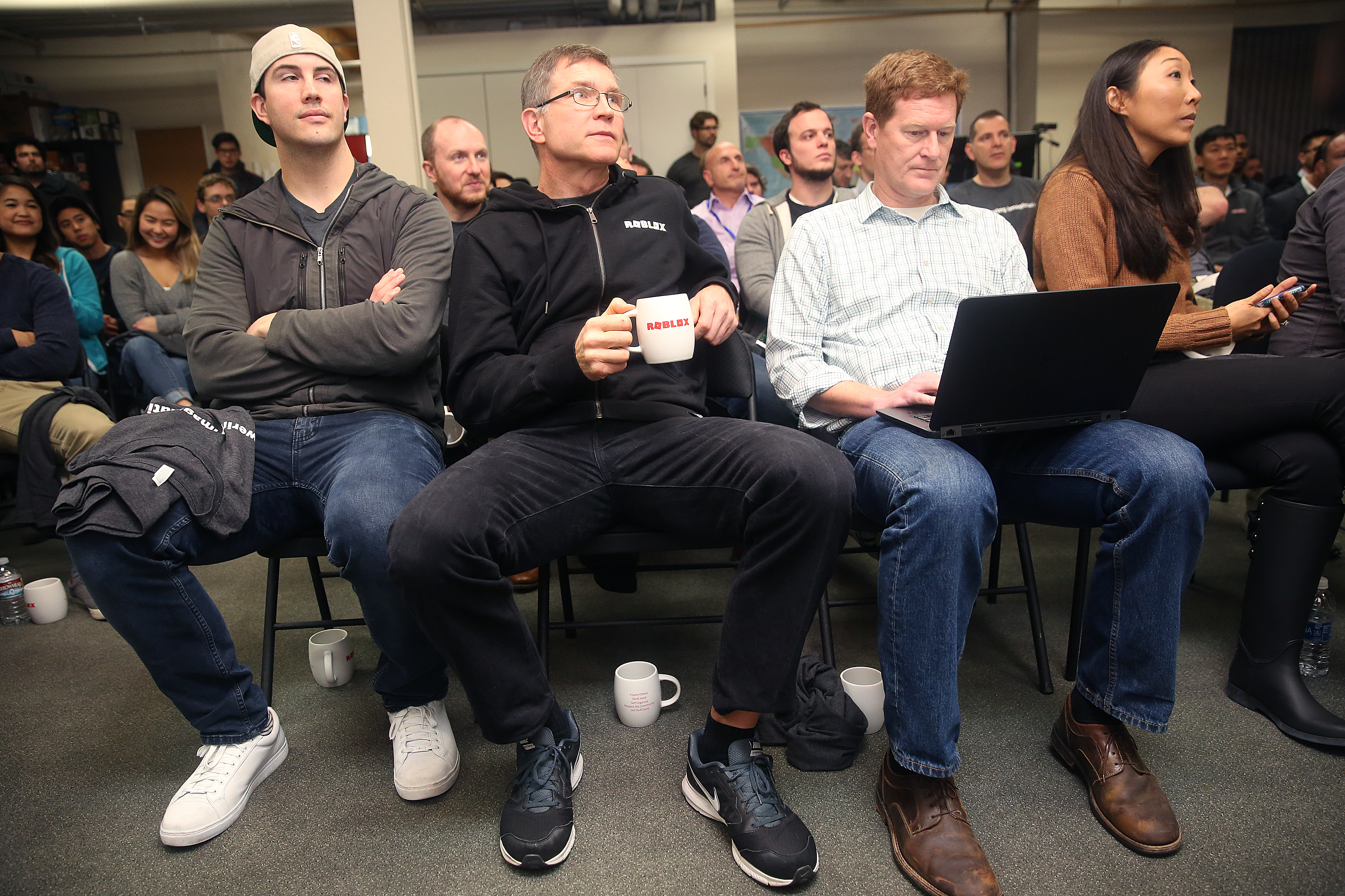 Roblox CEO David Baszucki (middle) sits between other Roblox employees during a lunch meeting in 2017.