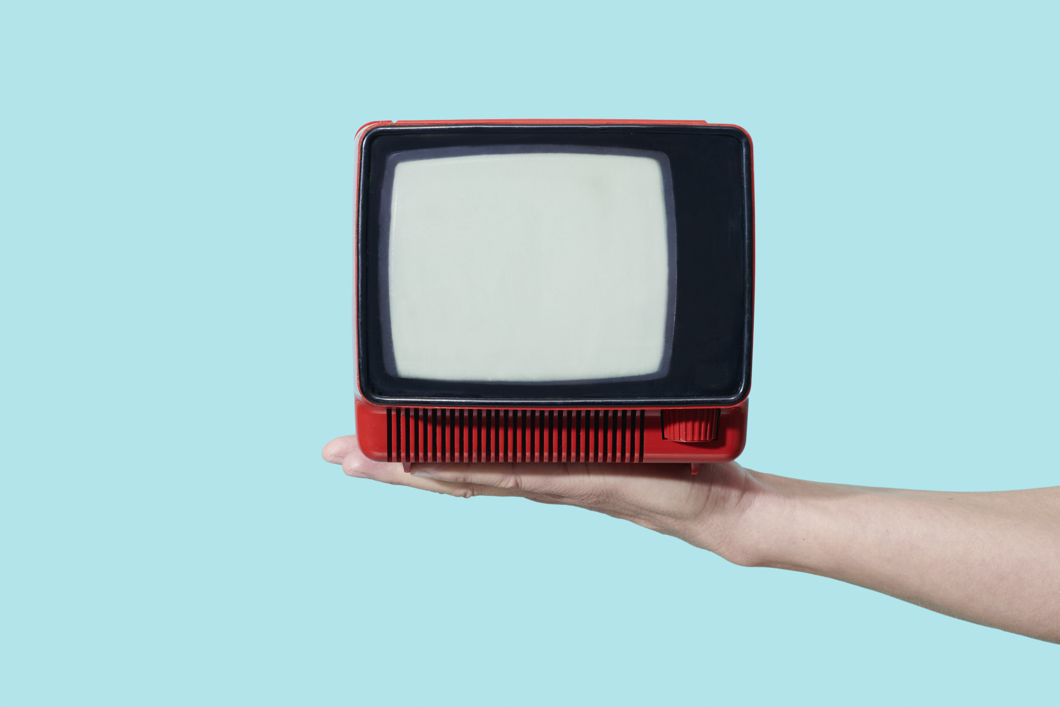 man has an old analog television set