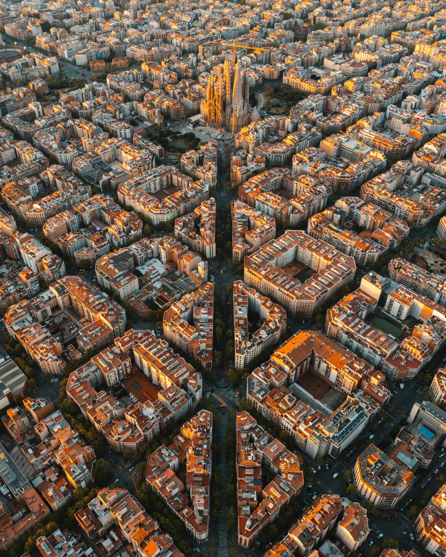 Aerial view of Barcelona Eixample residential district and famous Basilica Sagrada Familia at sunrise. Catalonia, Spain