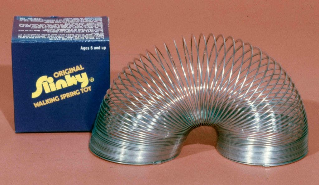A Slinky is a precompressed helical spring toy invented by Richard James in the early 1940s