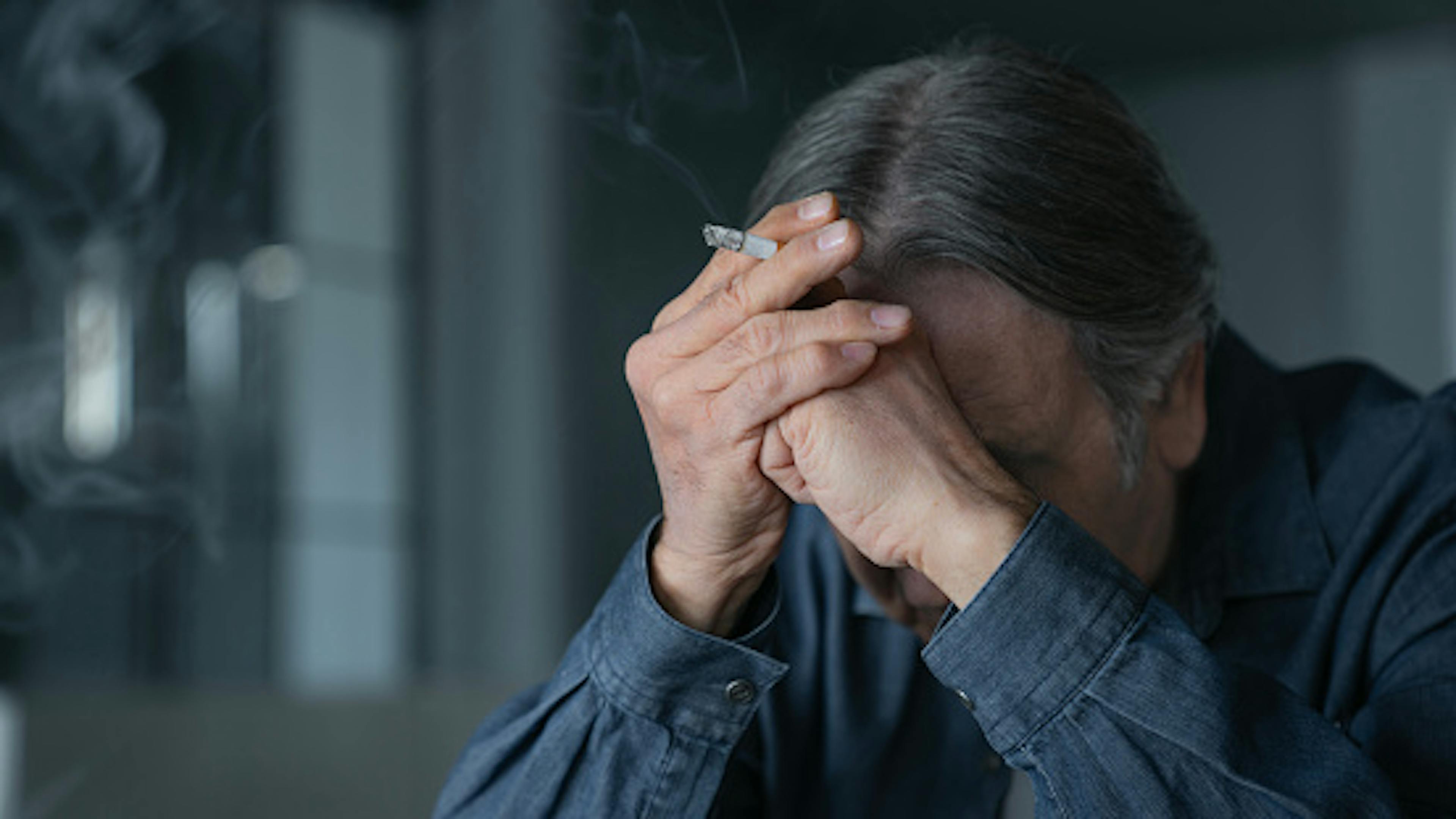 Old man smoking a cigarette