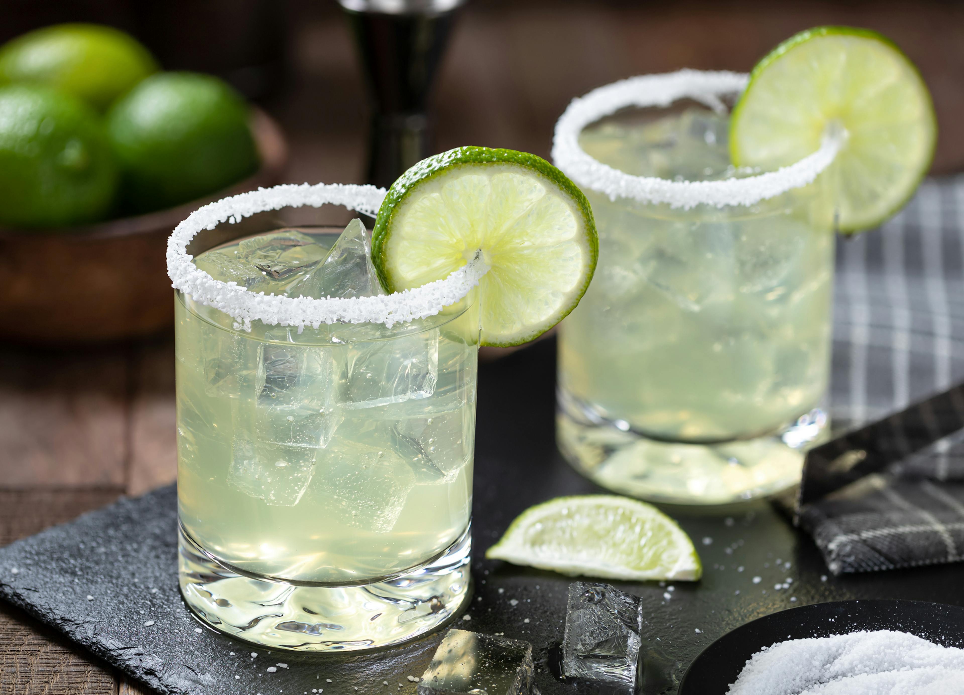 Margarita cocktail with ice, lime and salt riim
