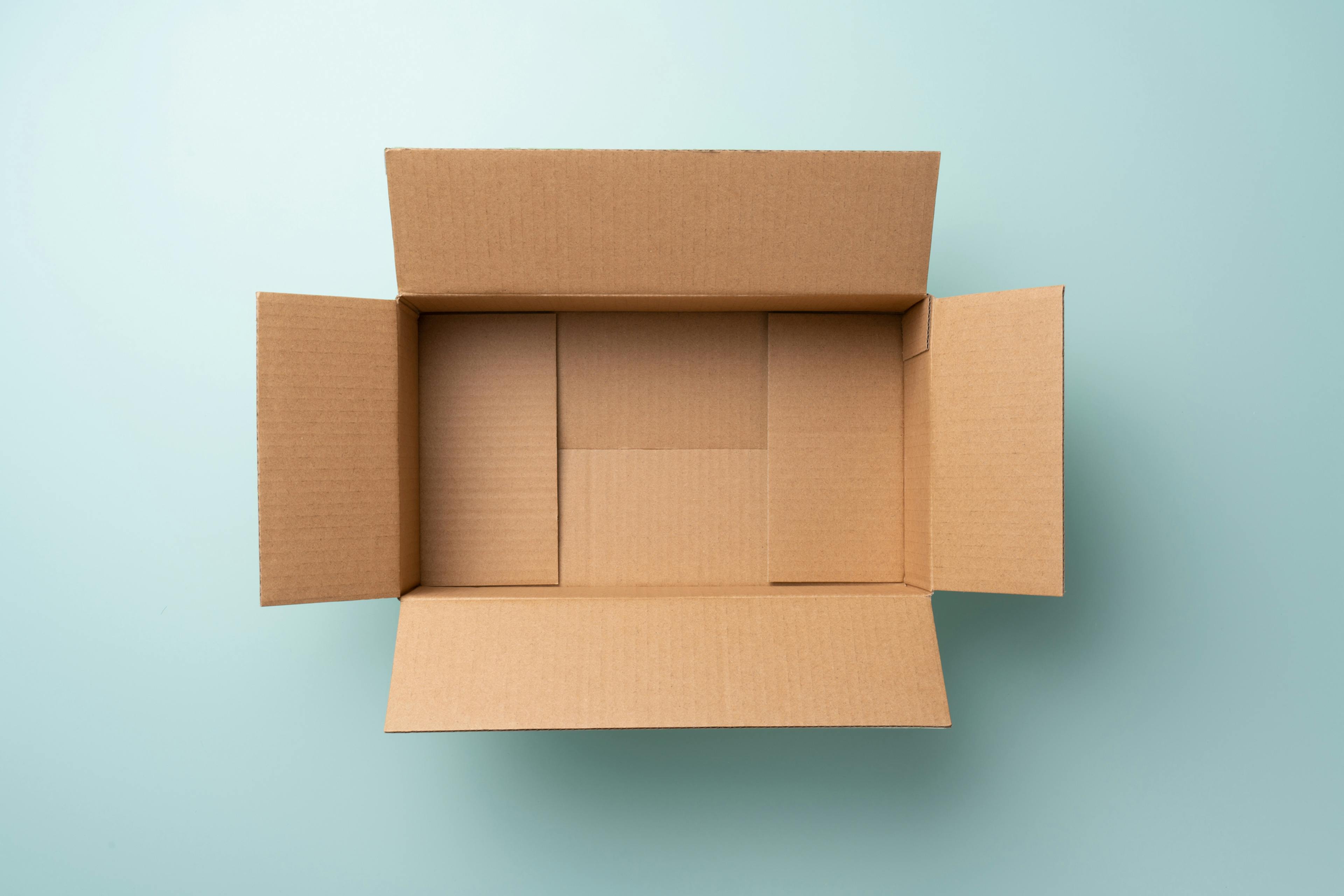 Opened Empty Cardboard Box on Blue Background