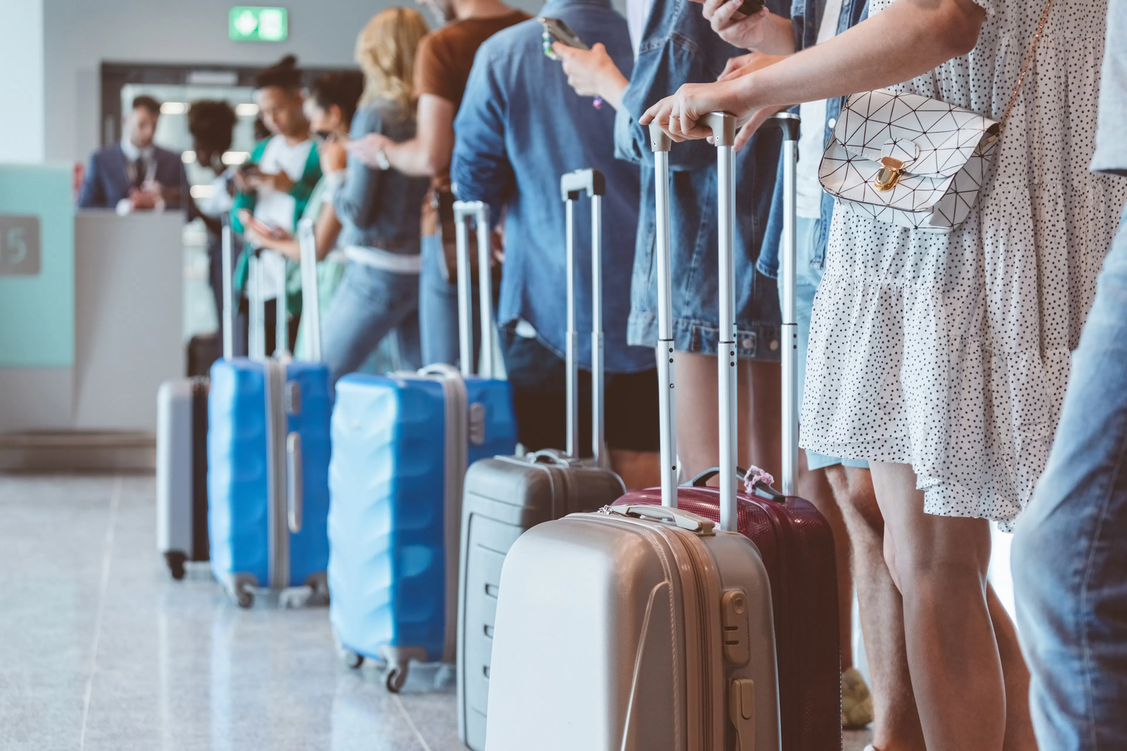 Group of people standing in queue at boarding gate