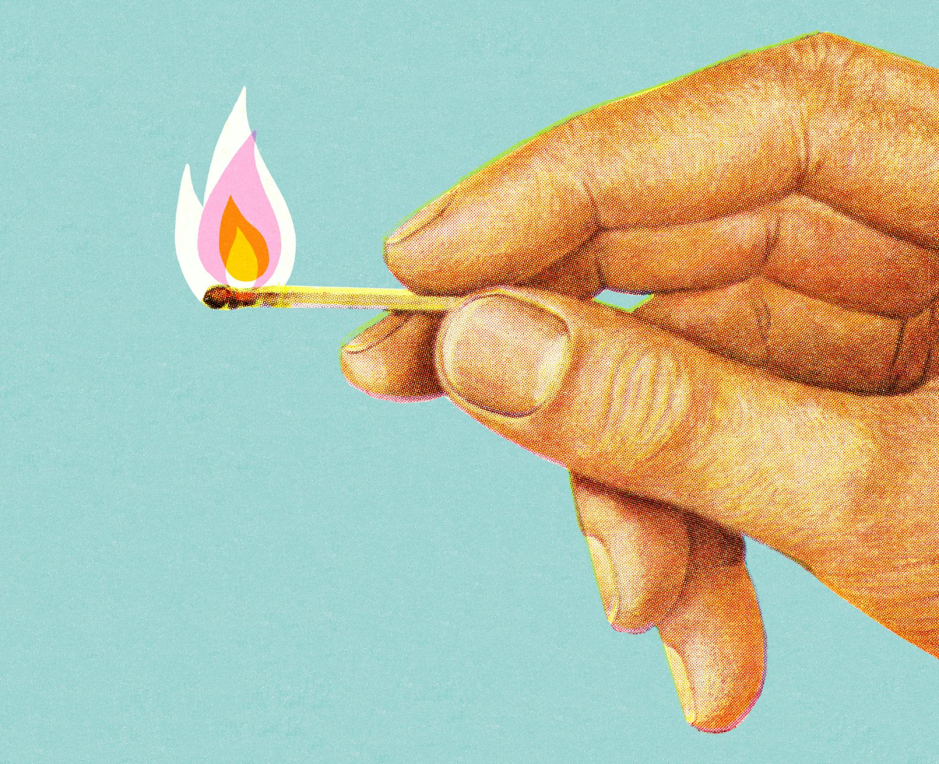 Hand Holding Lit Match