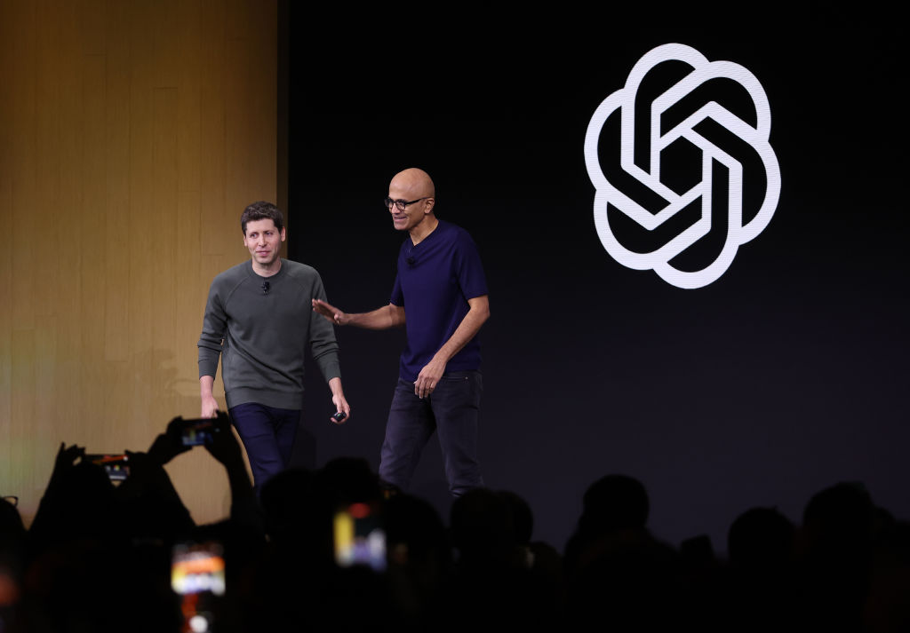 Microsoft CEO Satya Nadella (R) greets OpenAI CEO Sam Altman during the OpenAI DevDay event