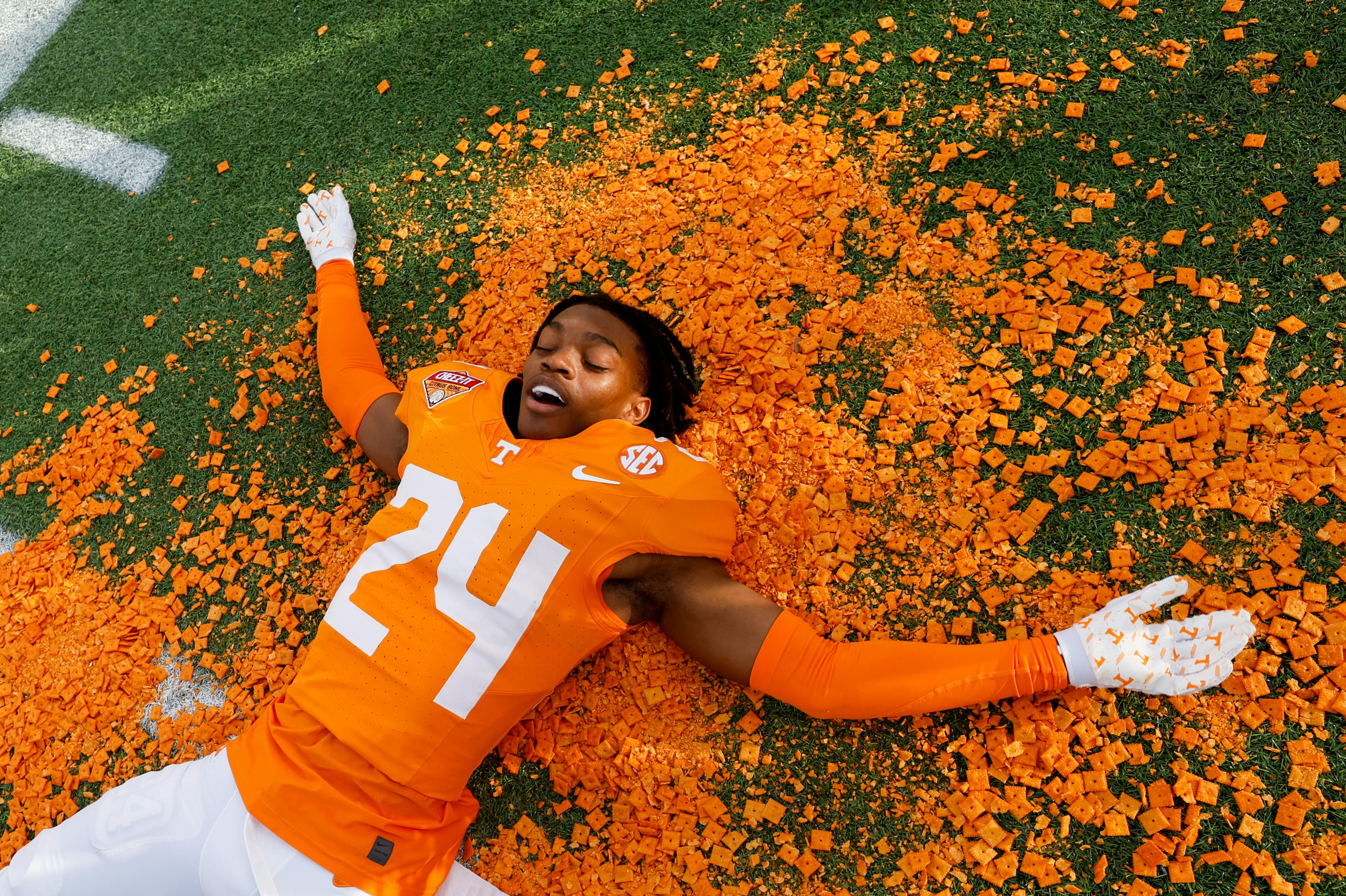Football player laying in cheez-its / cheez-its bowl