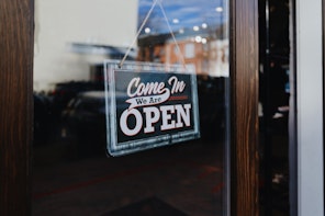 Open Sign Hangs From Store's Front Door