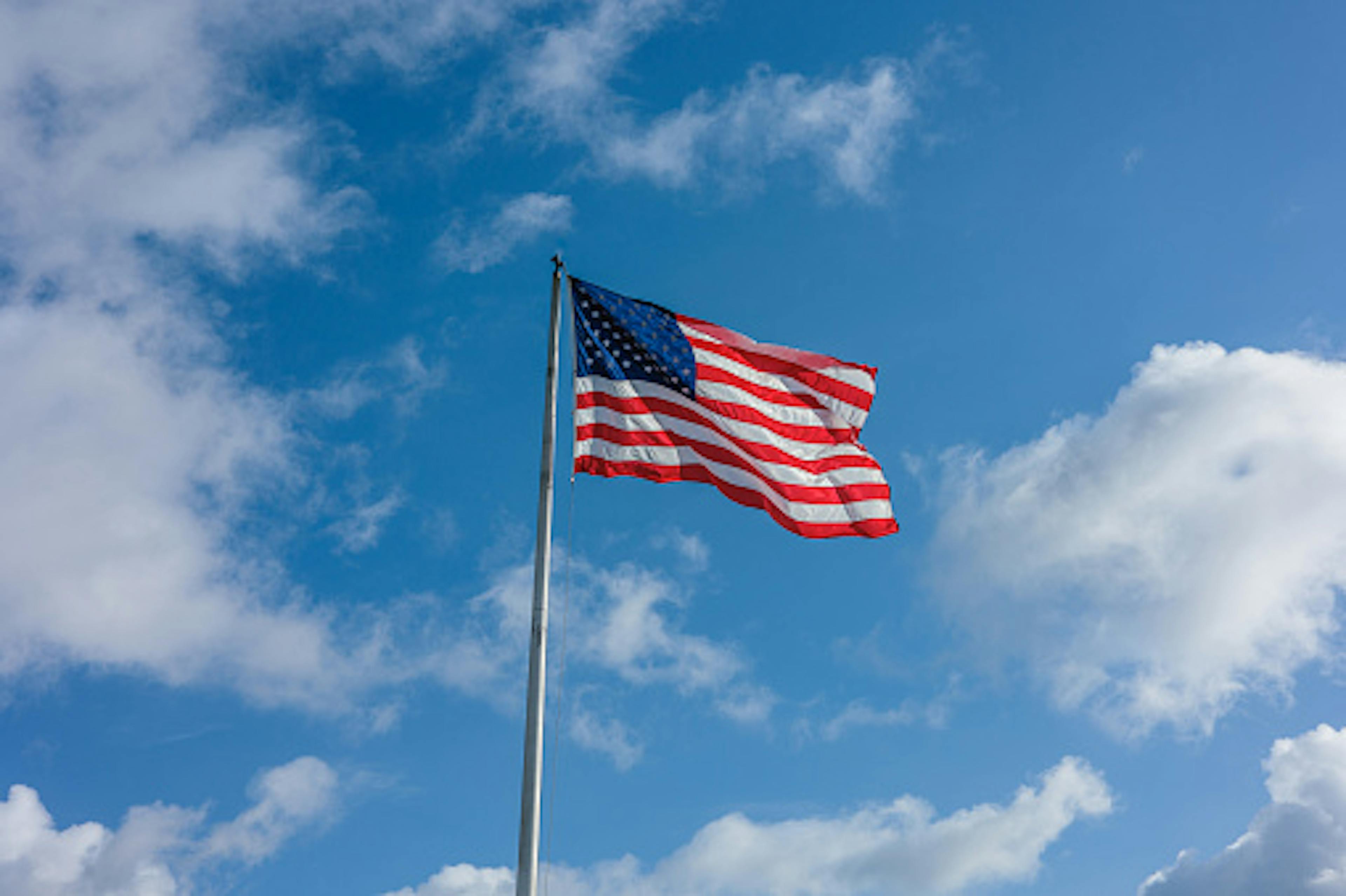 american flag on blue sky