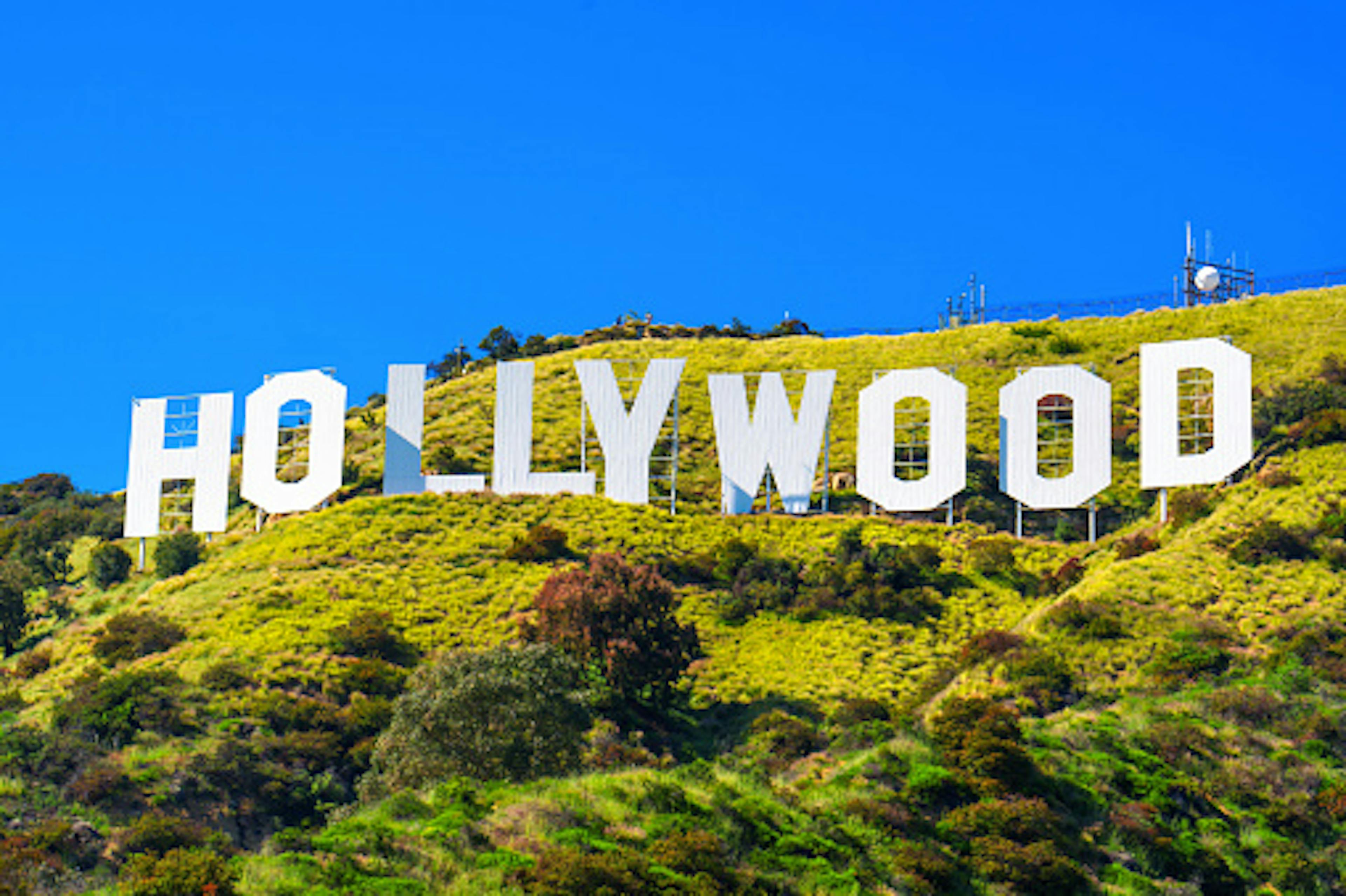Bright White Hollywood Sign Against Spring Greenery and Blue Sky