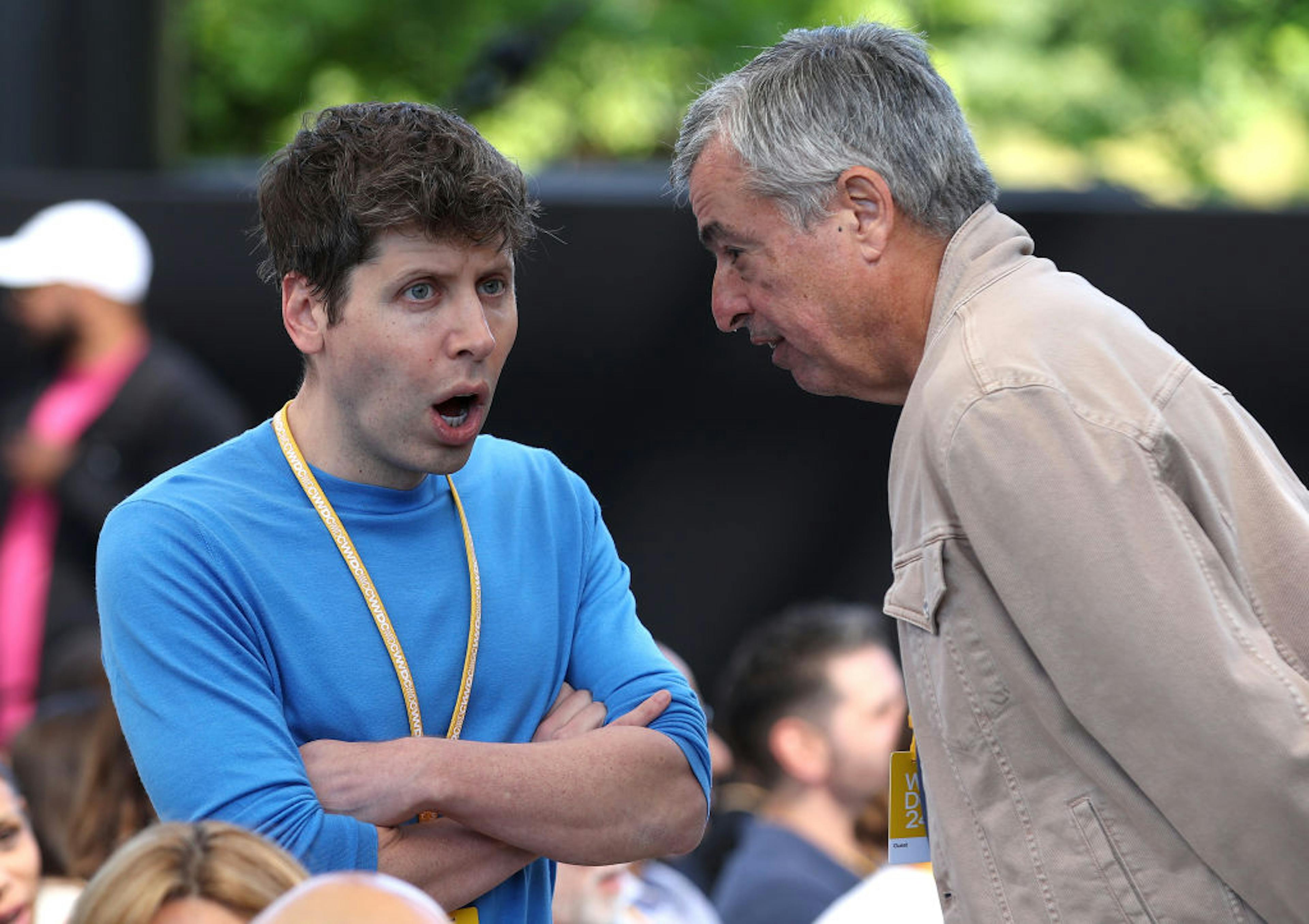 OpenAI CEO Sam Altman talks with Apple senior Vice President of Services Eddy Cue during WWDC 2024