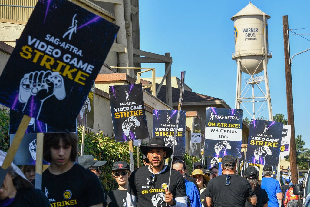 Video game workers striking in front of WB water tower