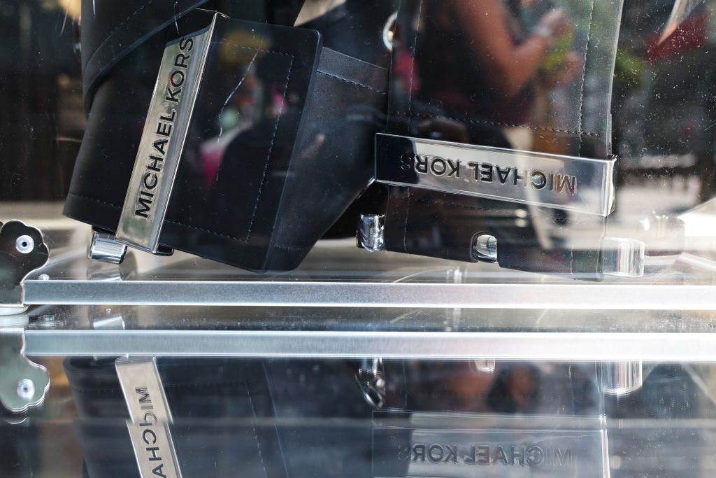 Maker of Michael Kors handbags loses nearly half its value after courts block acquisition by parent company of Coach thumbnail