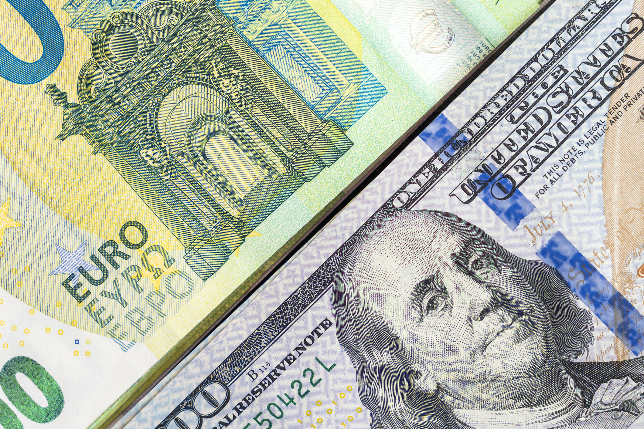 Pile American money banknote bills with European cash money banknotes, stacks of USA dollars, 100 one hundred dollars and 100 one hundred Euros papers exchange