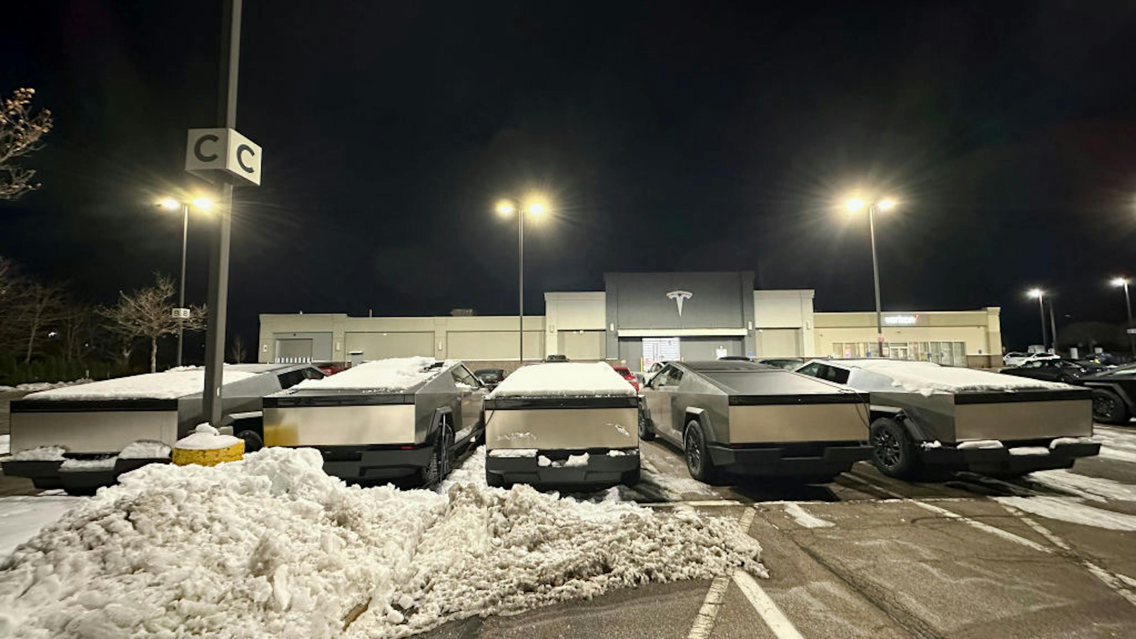 Tesla, cybertruck, truck, parked, car dealership, Boston, EV car, snow, car sales, transportation, modern, silver, logo, five objects, winter, night