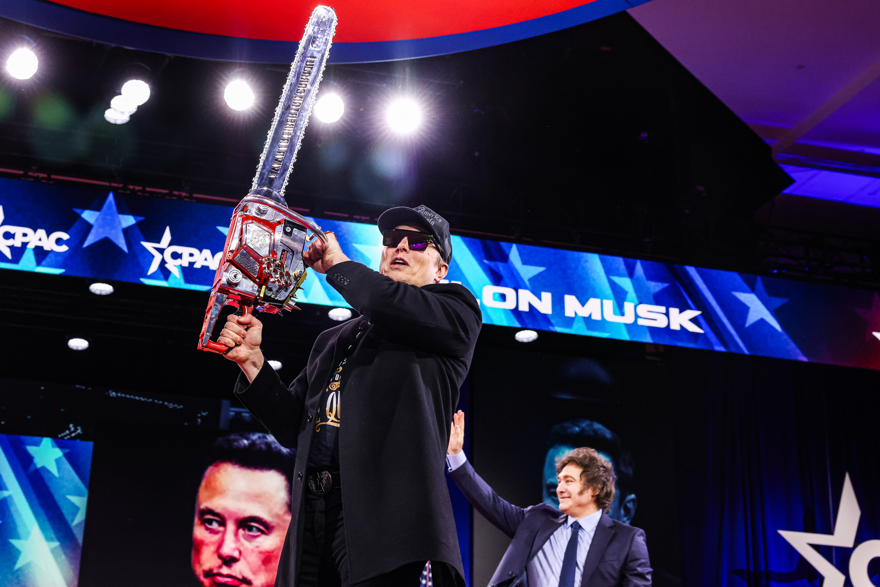 Elon Musk with chainsaw