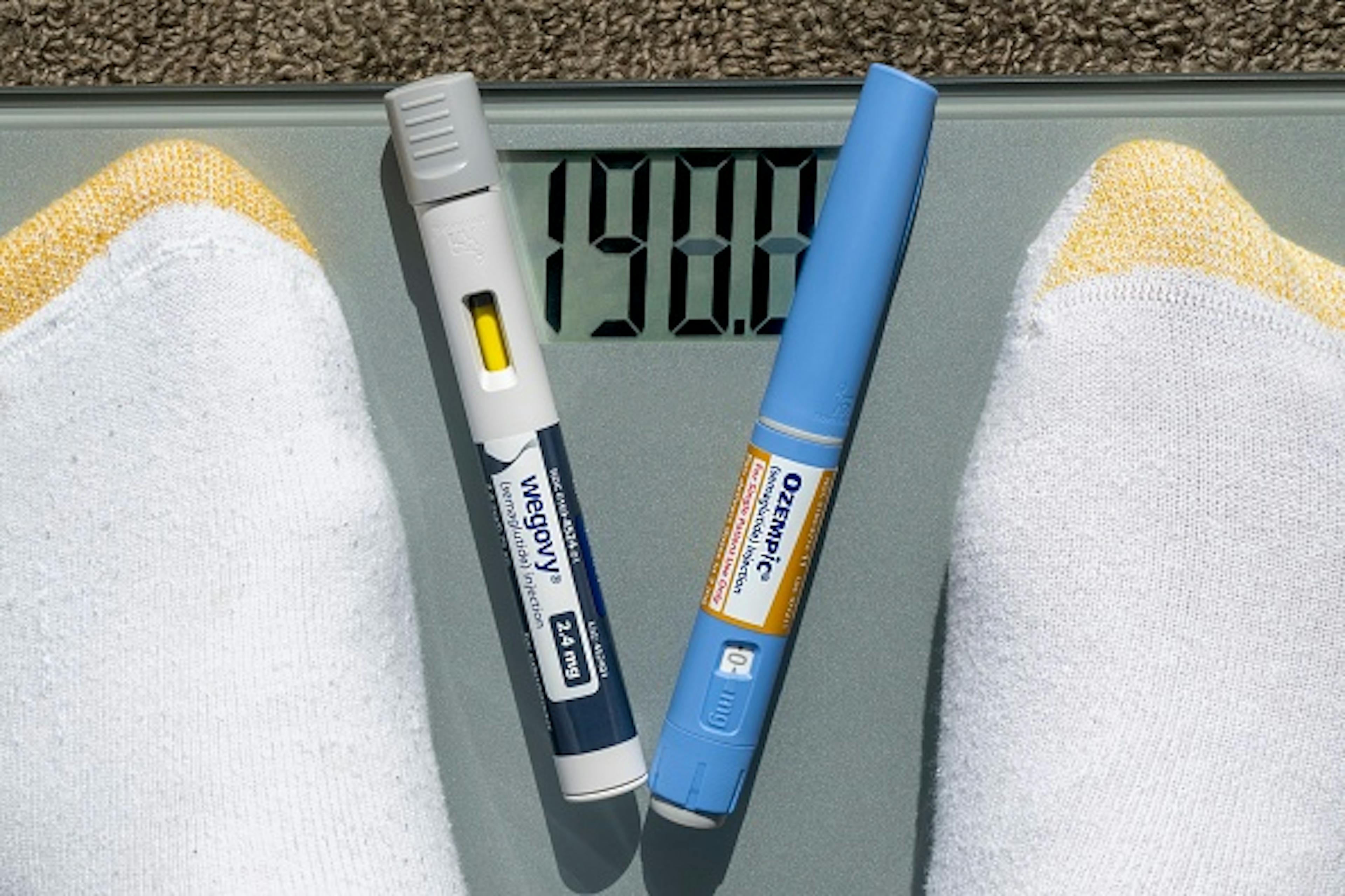 Still life of Ozempic and Wegovy with weight scale.