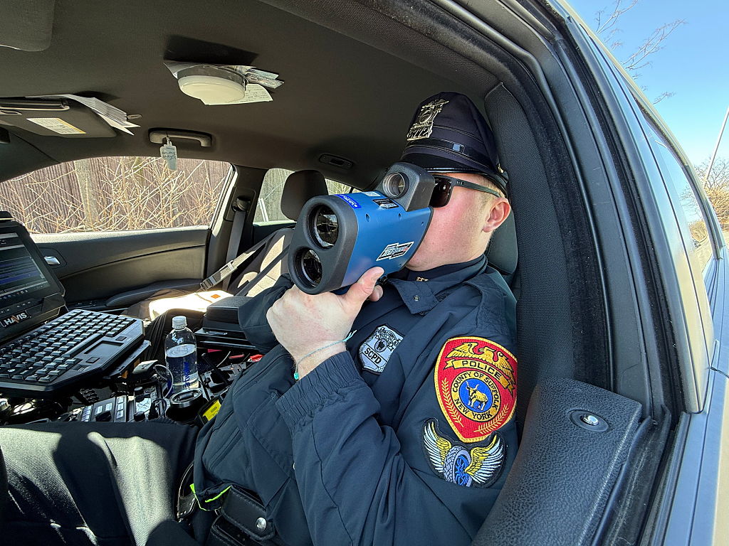 Long Island highway patrol officer using radar to check speed