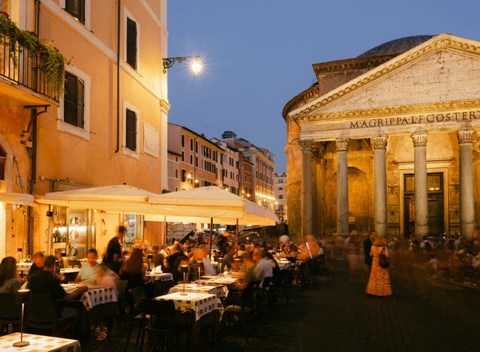 People dining outside in Piazza della Rotonda in Rome at dusk