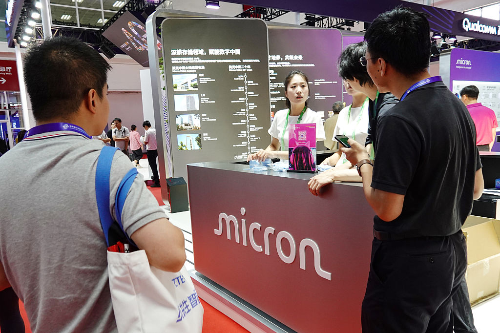 People interact at the Micron booth at the 3rd China...