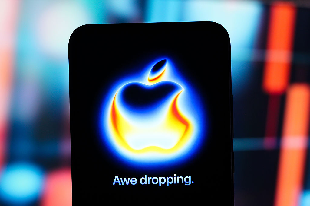 In this photo illustration, the Apple logo "Awe Dropping...