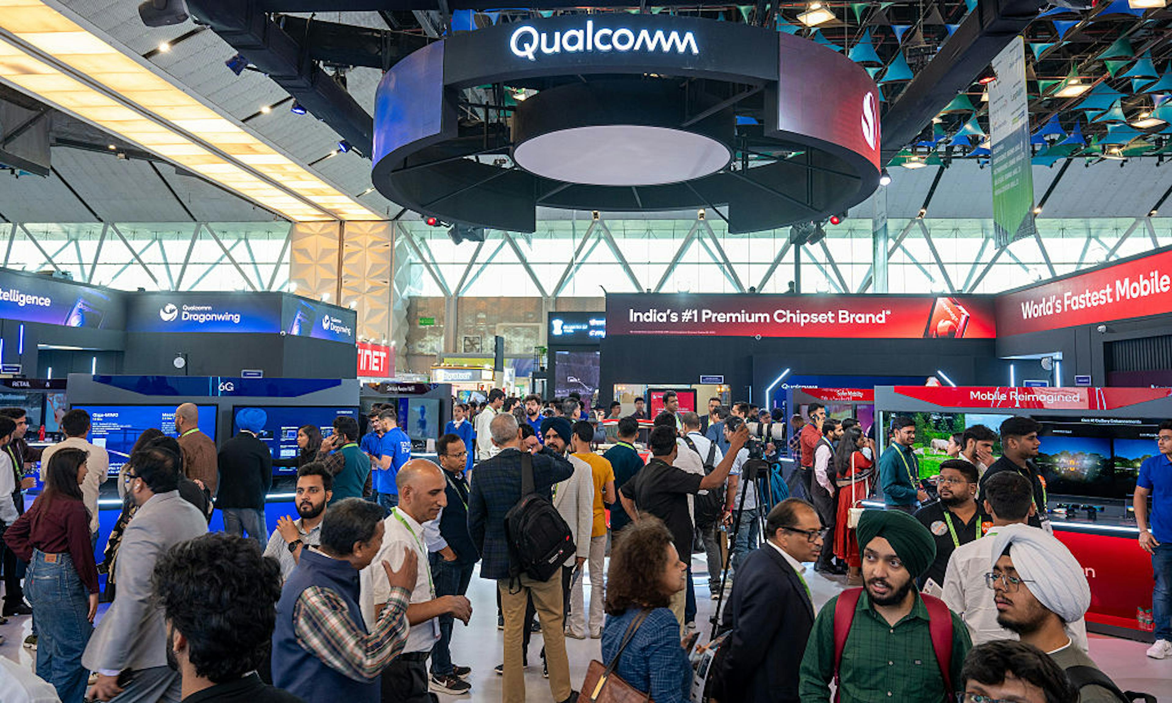 A crowd of visitors at the Qualcomm ( Qualcomm is an...
