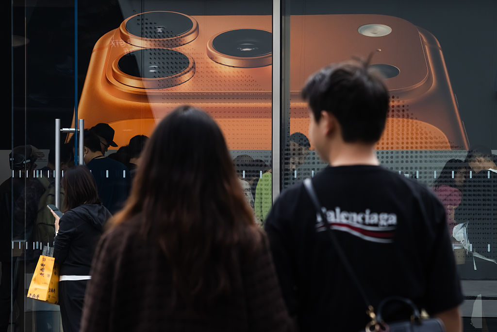 People Walk Past Apple Store Displaying iPhone 17 Pro Poster in Chengdu
