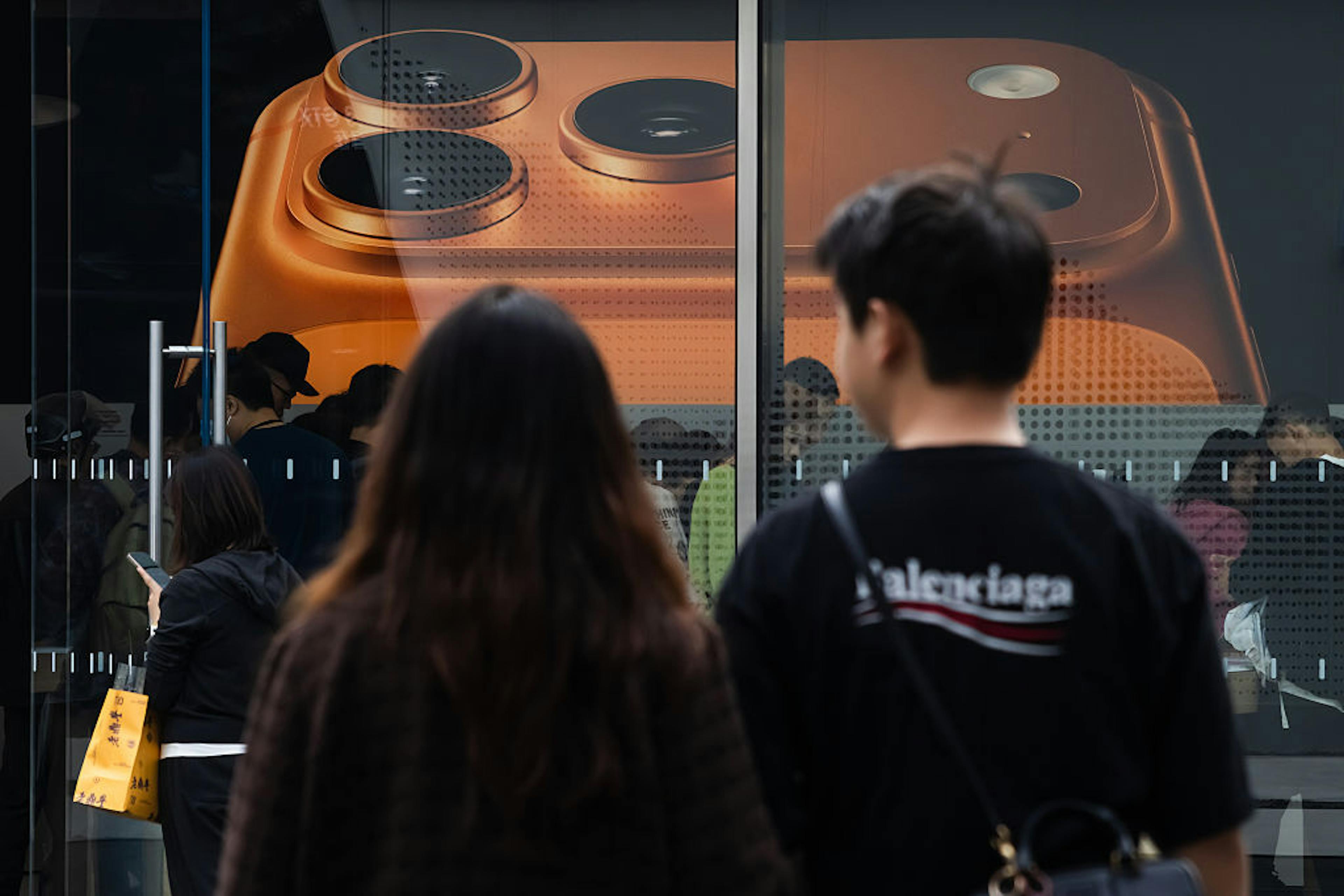 People Walk Past Apple Store Displaying iPhone 17 Pro Poster in Chengdu